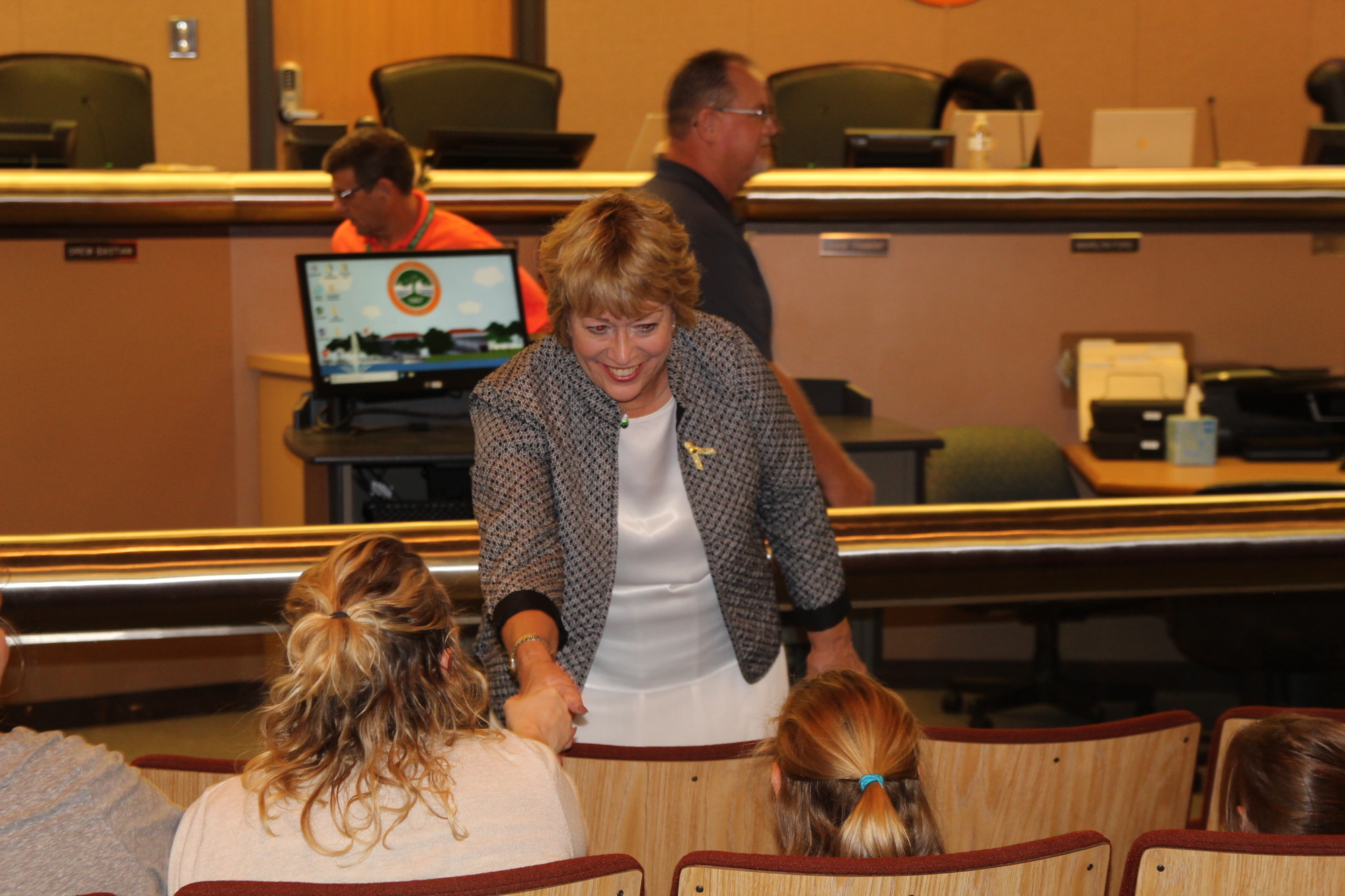 City councilwoman Marilyn Ford greets a young guest at the Go Gold! proclamation. Photo by Tanya Russo