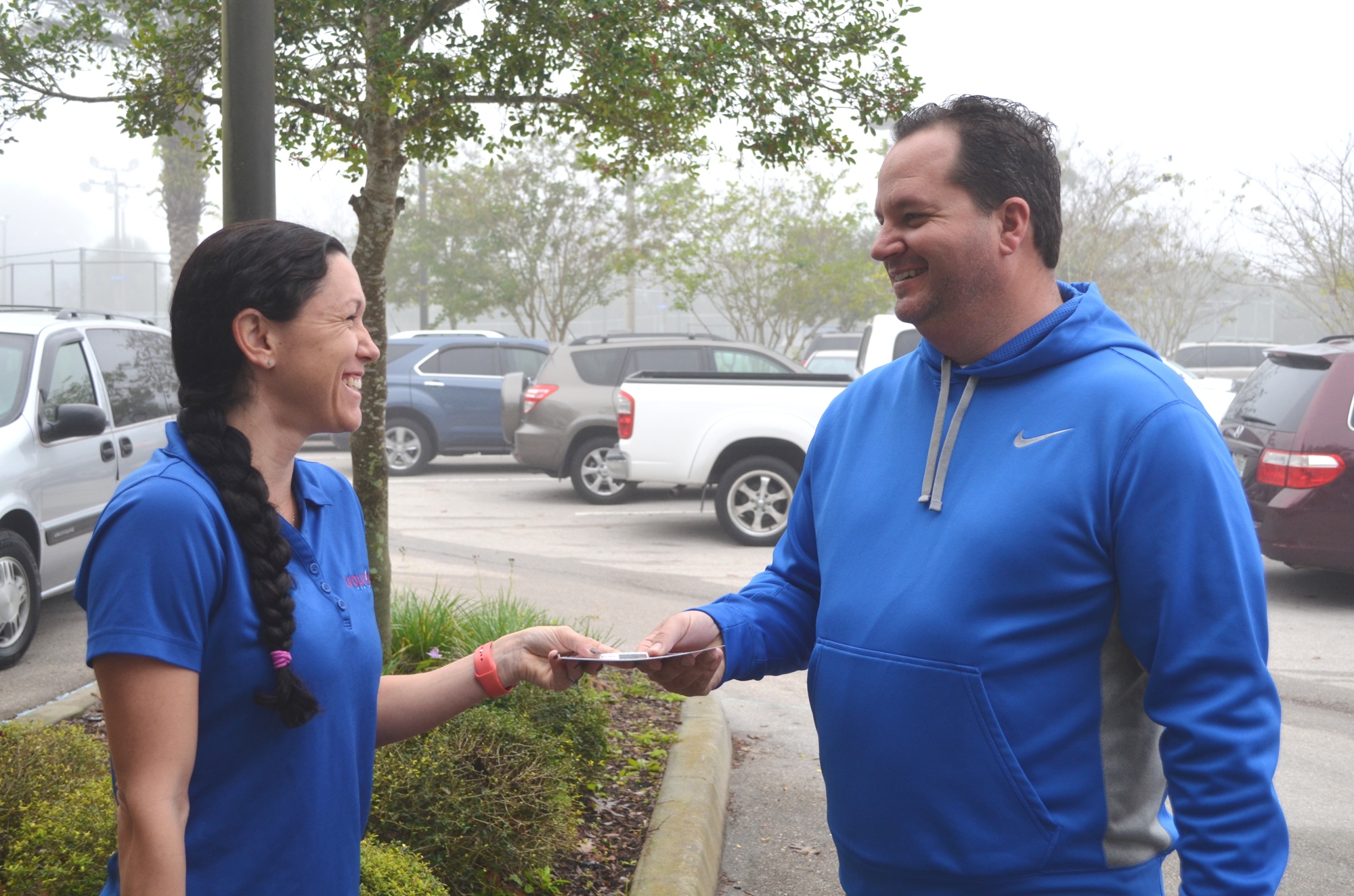 Christie Bennett of Evolution Health Club hands a flyer to City Commissioner Troy Kent who signed up for the Mayor’s Challenge. Photos by Wayne Grant