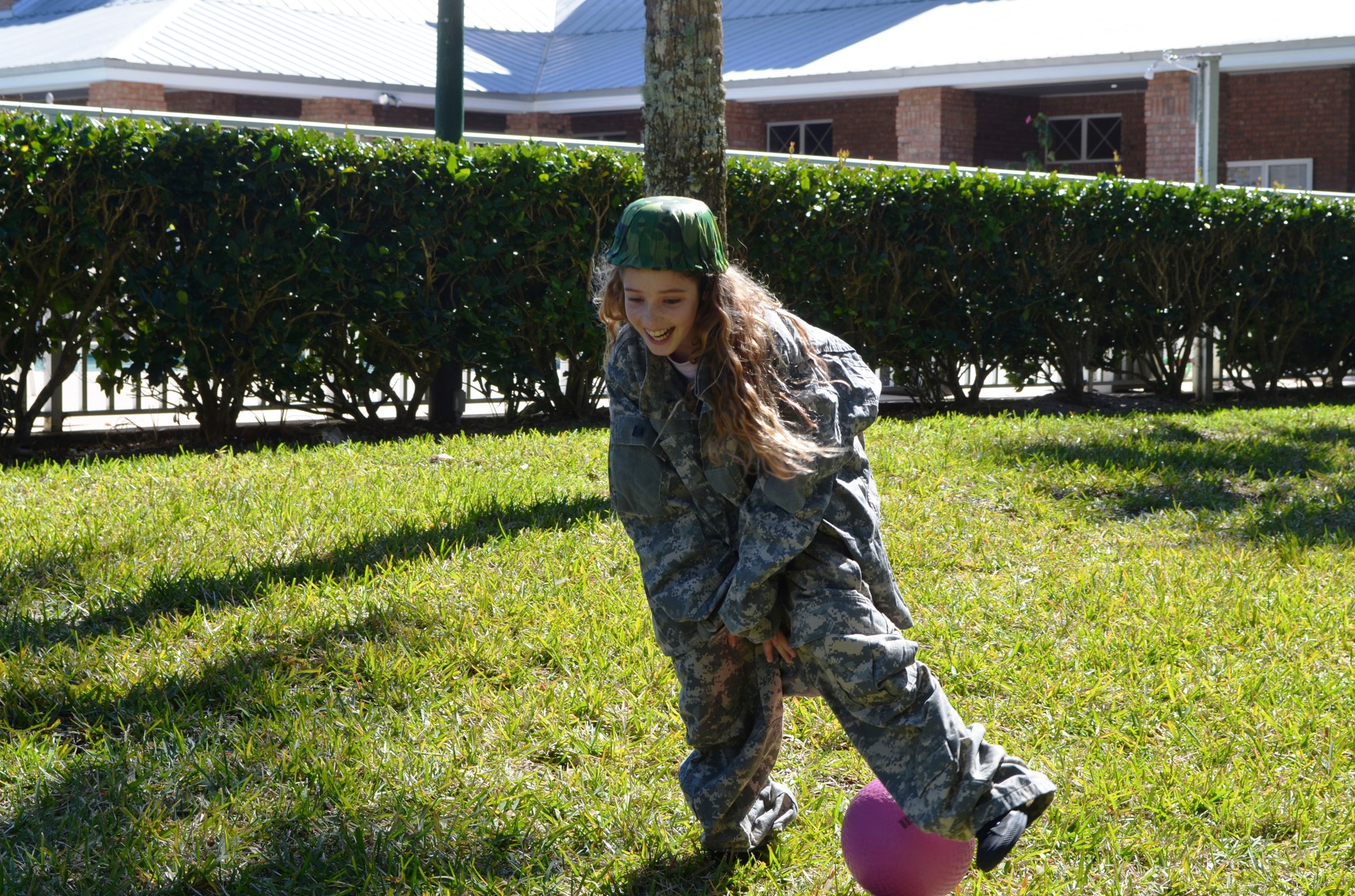 Young people such as Skylar Chamberlain dressed in fatigues to run an obstacle course.