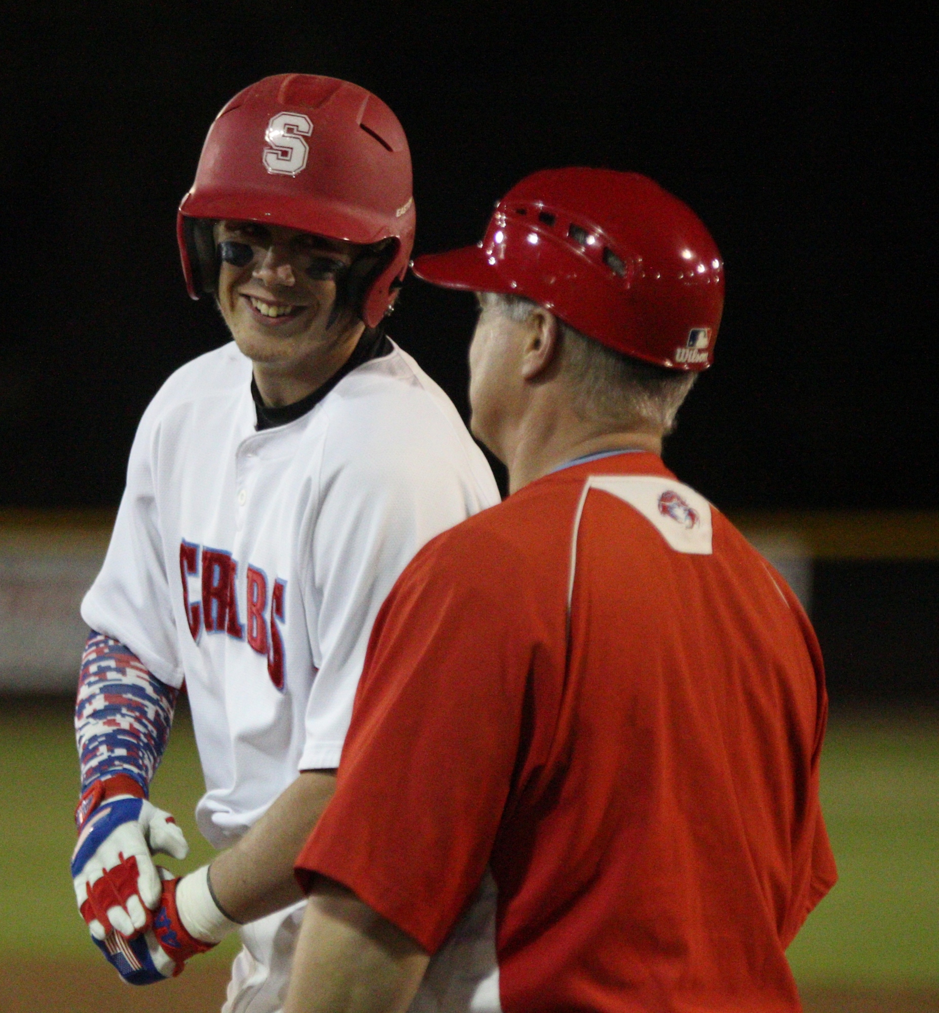 Trevor Vanyo cracks a smile with first base coach Randy Rorrer, after his single drove in two runners.