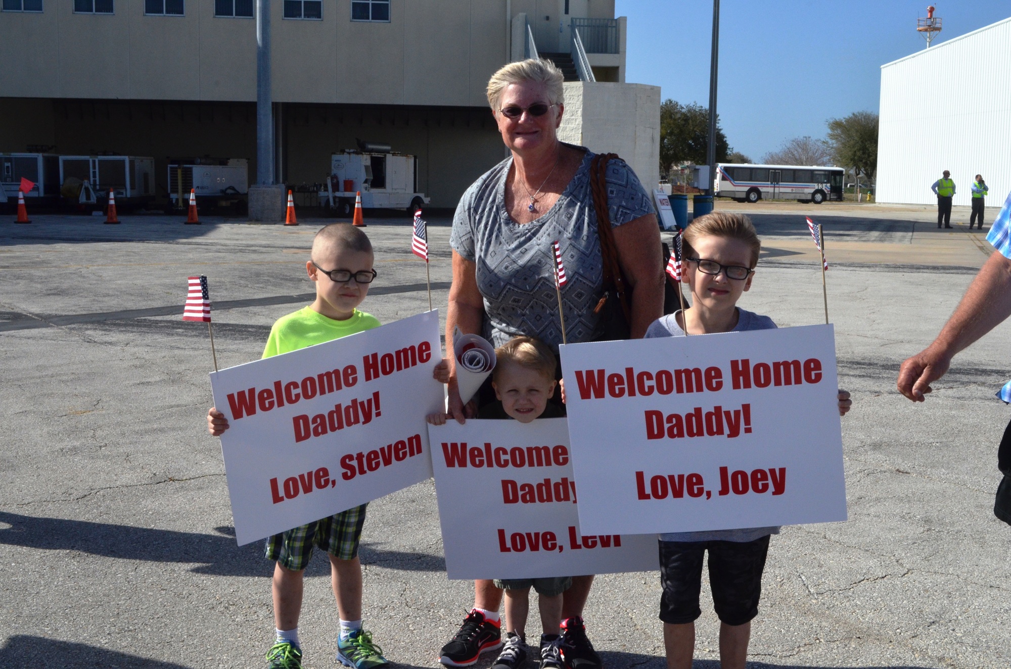 Steven, Levi and Joey Bair, of Palm Coast, wait for their dad, Sgt. Joseph Bair. They are shown with their grandmother, Cathy.