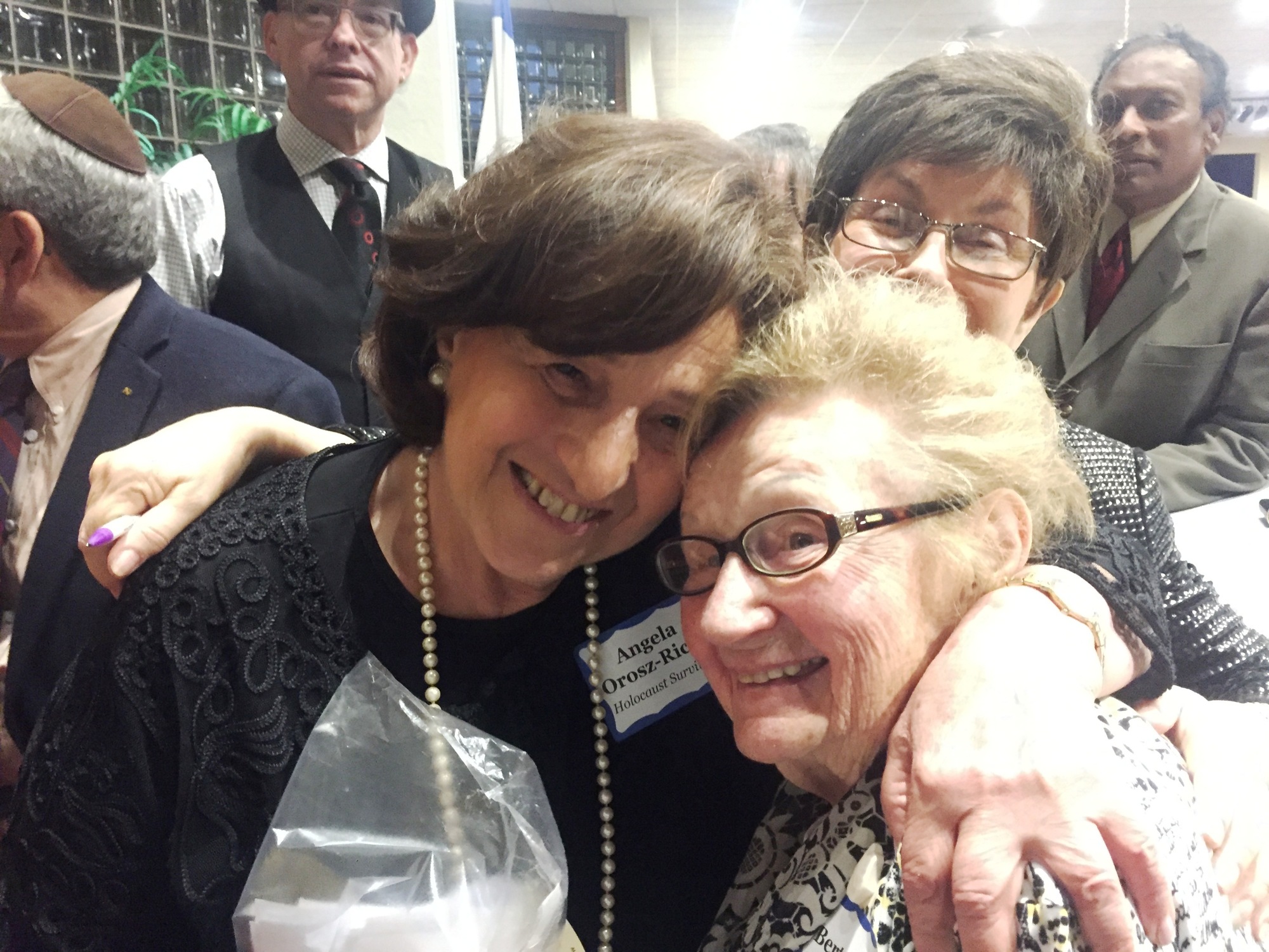 Shown are Angela Orosz, who survived Auschwitz as a baby, and Berta Wohl, 95, the oldest Holocaust survivor at the Holocaust Memorial Observance. Looking on is Gloria Max, executive director of the Jewish Federation of Volusia and Flagler Counties.Courte