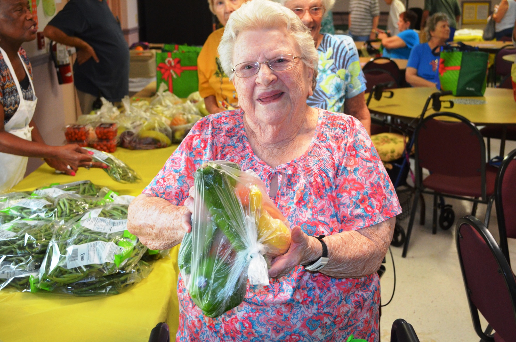 Lula Turner shows the vegetables she just picked up.