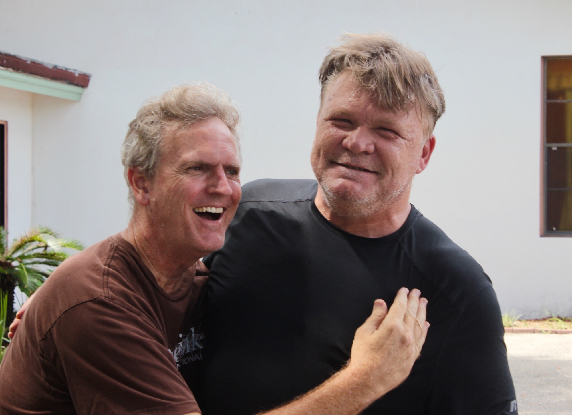 Doug Hautz and shelter resident Norris Langley share a hug. Photo by Ray Boone