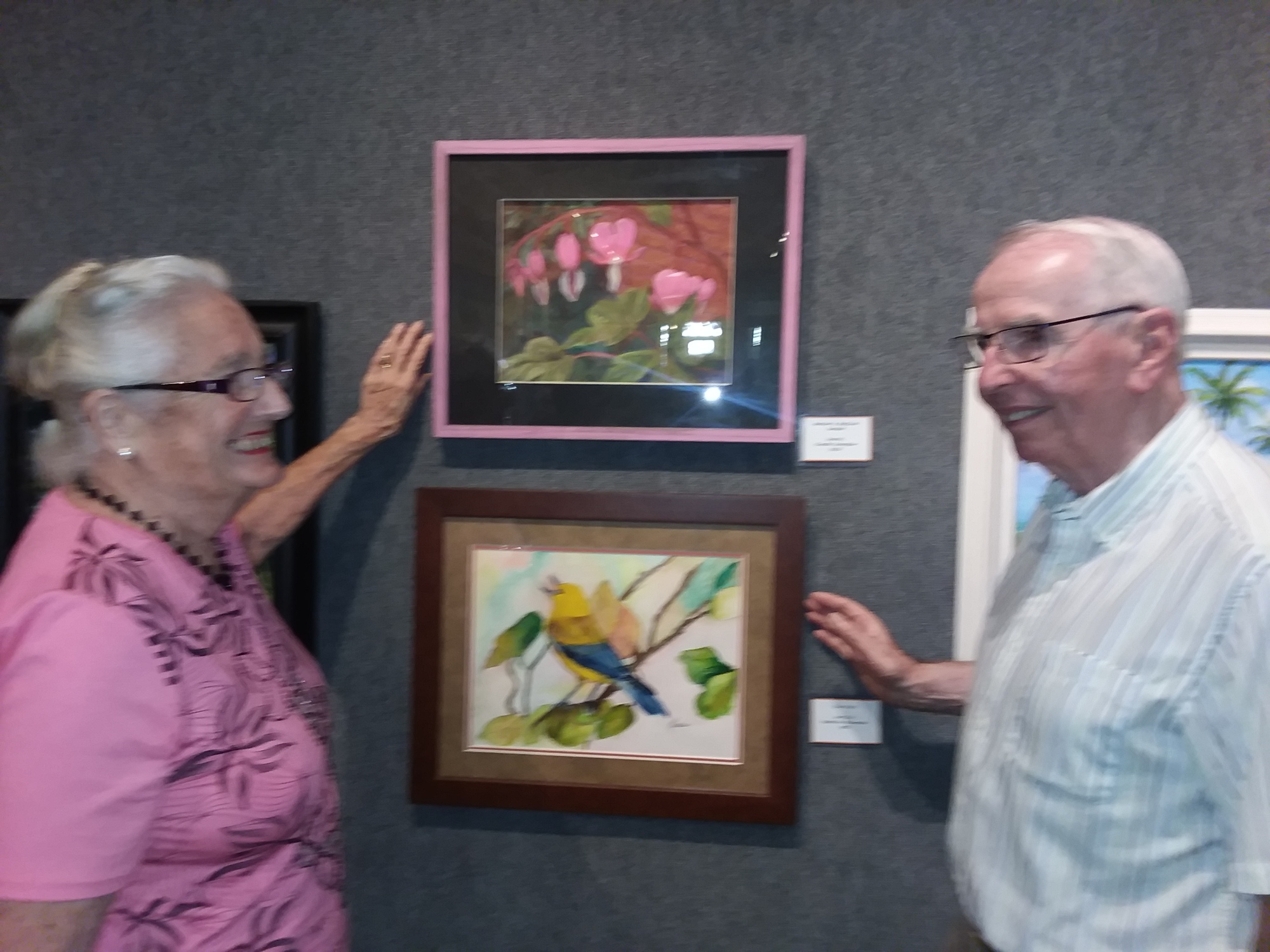Maxine and Tony Bradley of England admire pastel artwork, 