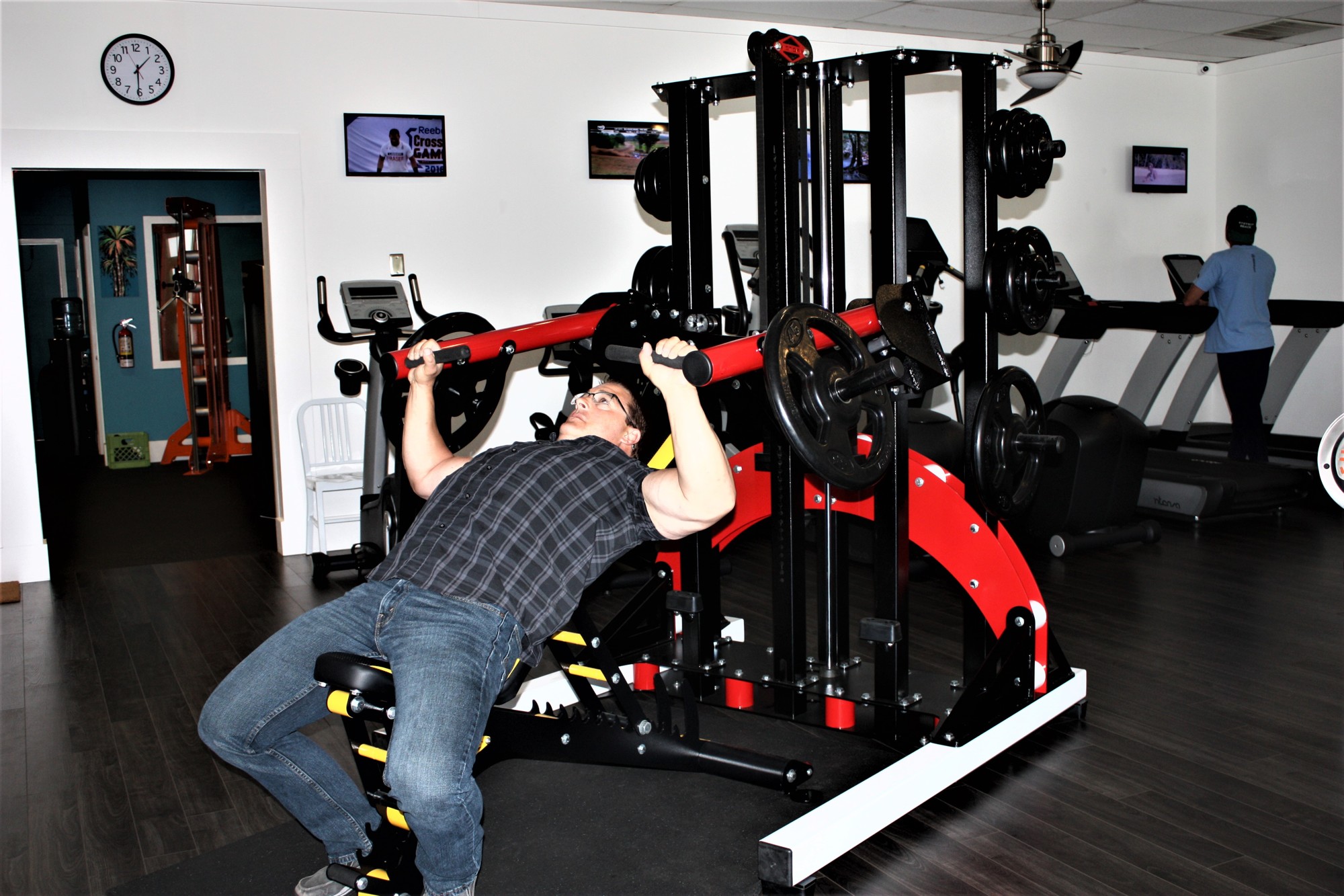 Cy Manula works out on his new machine, the Master Press. Photo by Wayne Grant