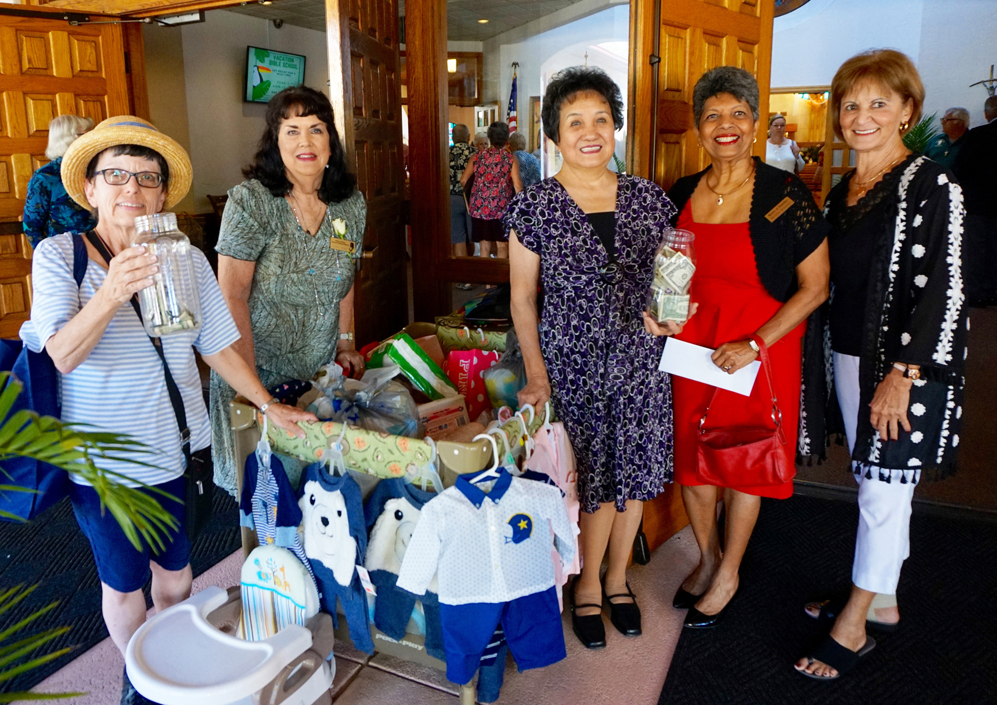 Marcia Rudman, Elena Torres, Theresa Ho, Marlene Braganza and Yvonne Turnbull are collecting items after mass for the Prince of Peace Council of Catholic Women’s Mother’s Day Baby Shower. Courtesy photo