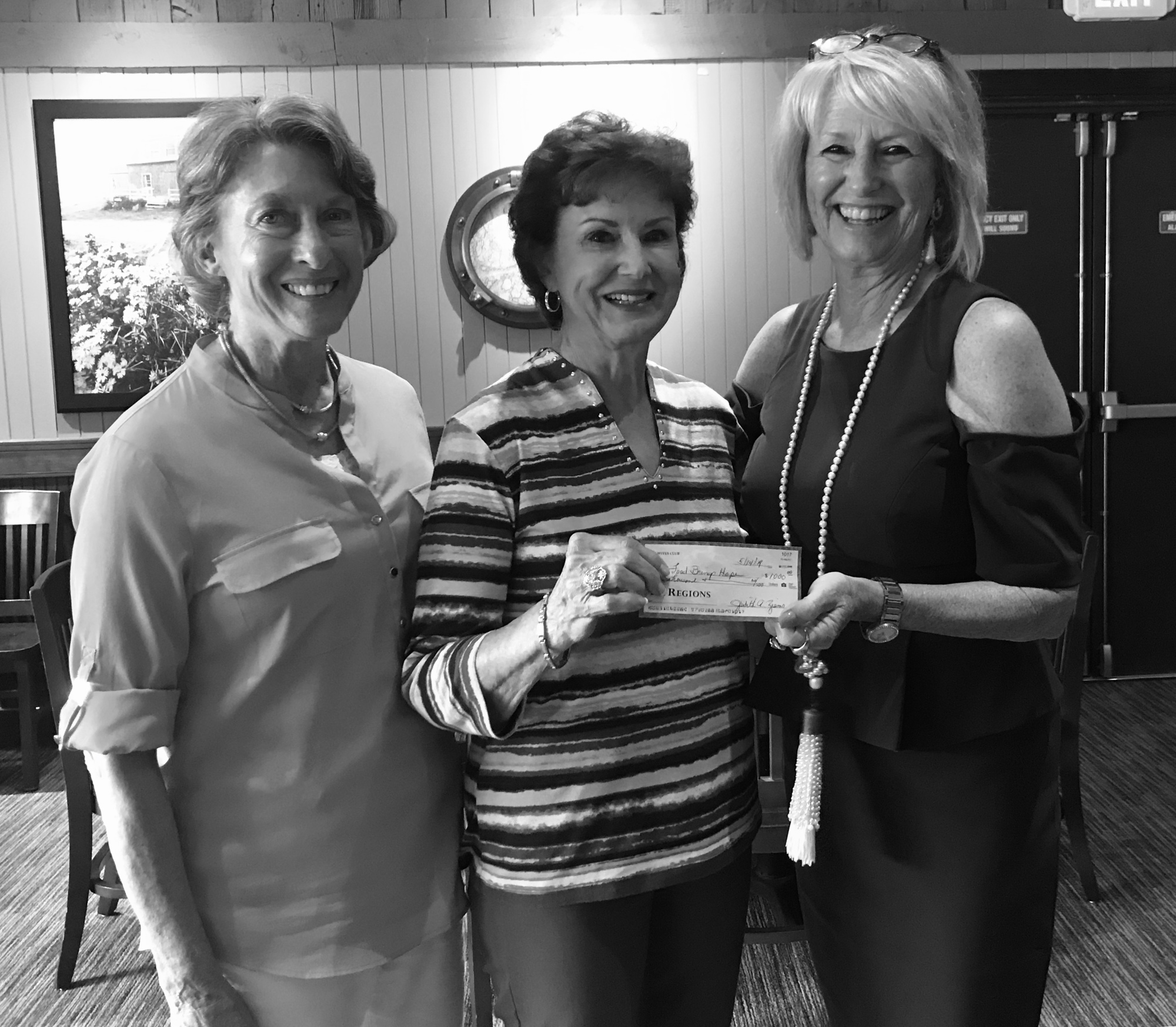 GE Wives Club members Harriett Anderson  and Judy Ziems, with Judi Winch, executive director of Food Brings Hope. Courtesy photo