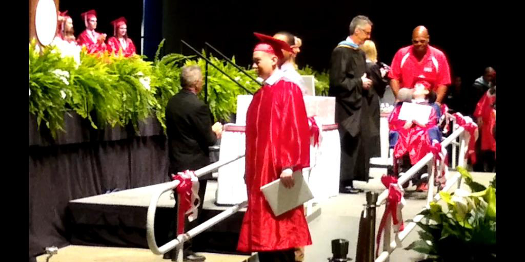 Michael Blavis walks across the stage during his Seabreeze High School graduation. Courtesy photo