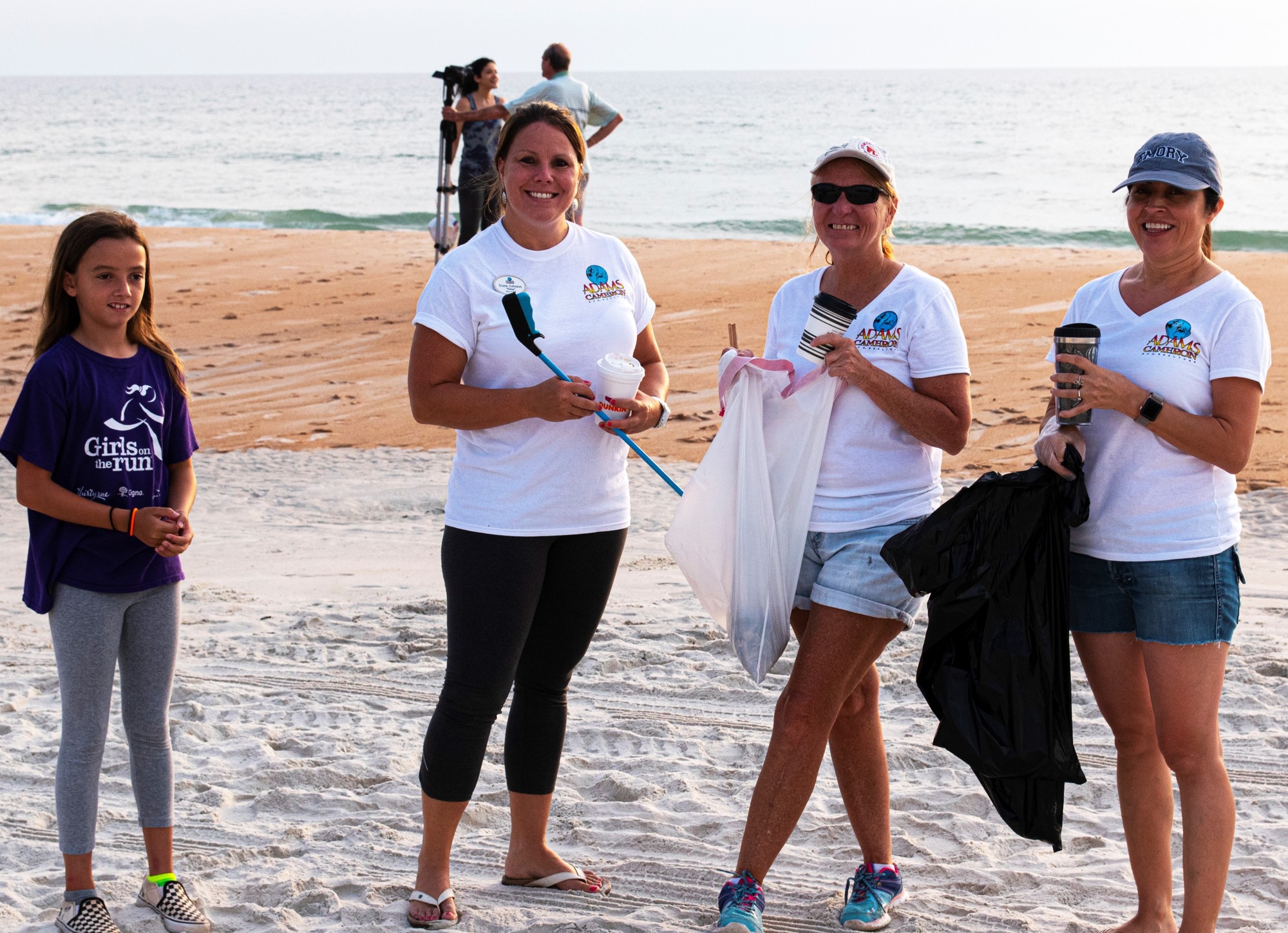 Adams, Cameron and Co., Realtors gathered trash on the beach after July 4. Courtesy photo Newton White