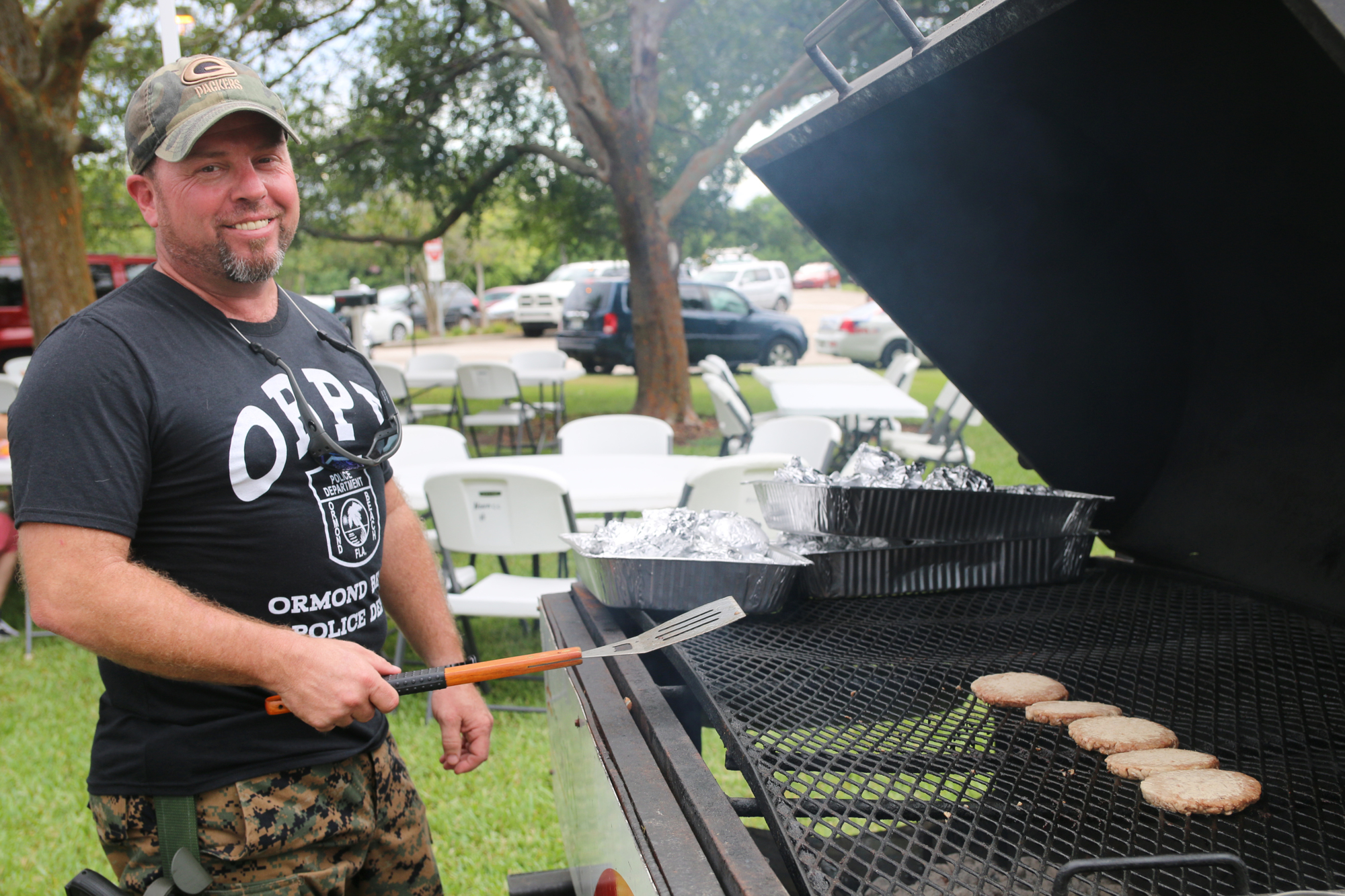 Capt. D.W. Smith grills some burger patties during the annual National Night Out event on Tuesday, Aug. 6. Photo by Jarleene Almenas