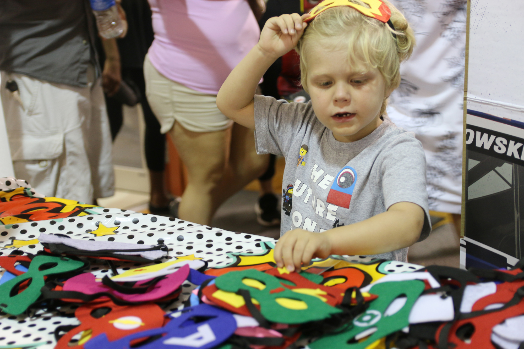 Brandon McClammy tries on masks during the annual National Night Out event on Tuesday, Aug. 6. Photo by Jarleene Almenas