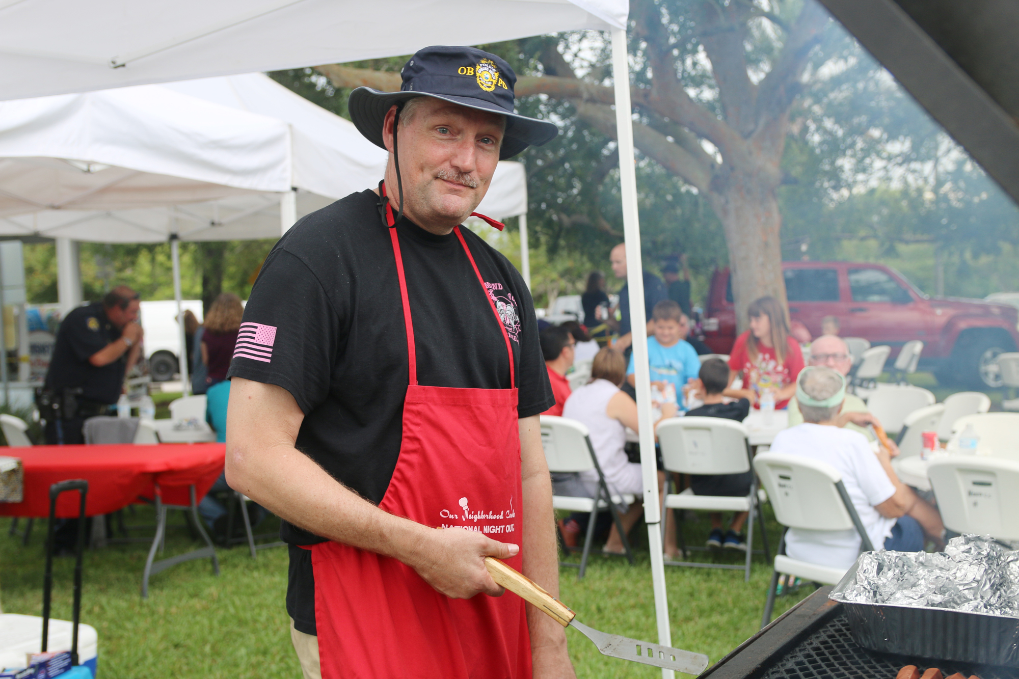 Ormond Beach Police Chief Jesse Godfrey grills food during the annual National Night Out event on Tuesday, Aug. 6. Photo by Jarleene Almenas
