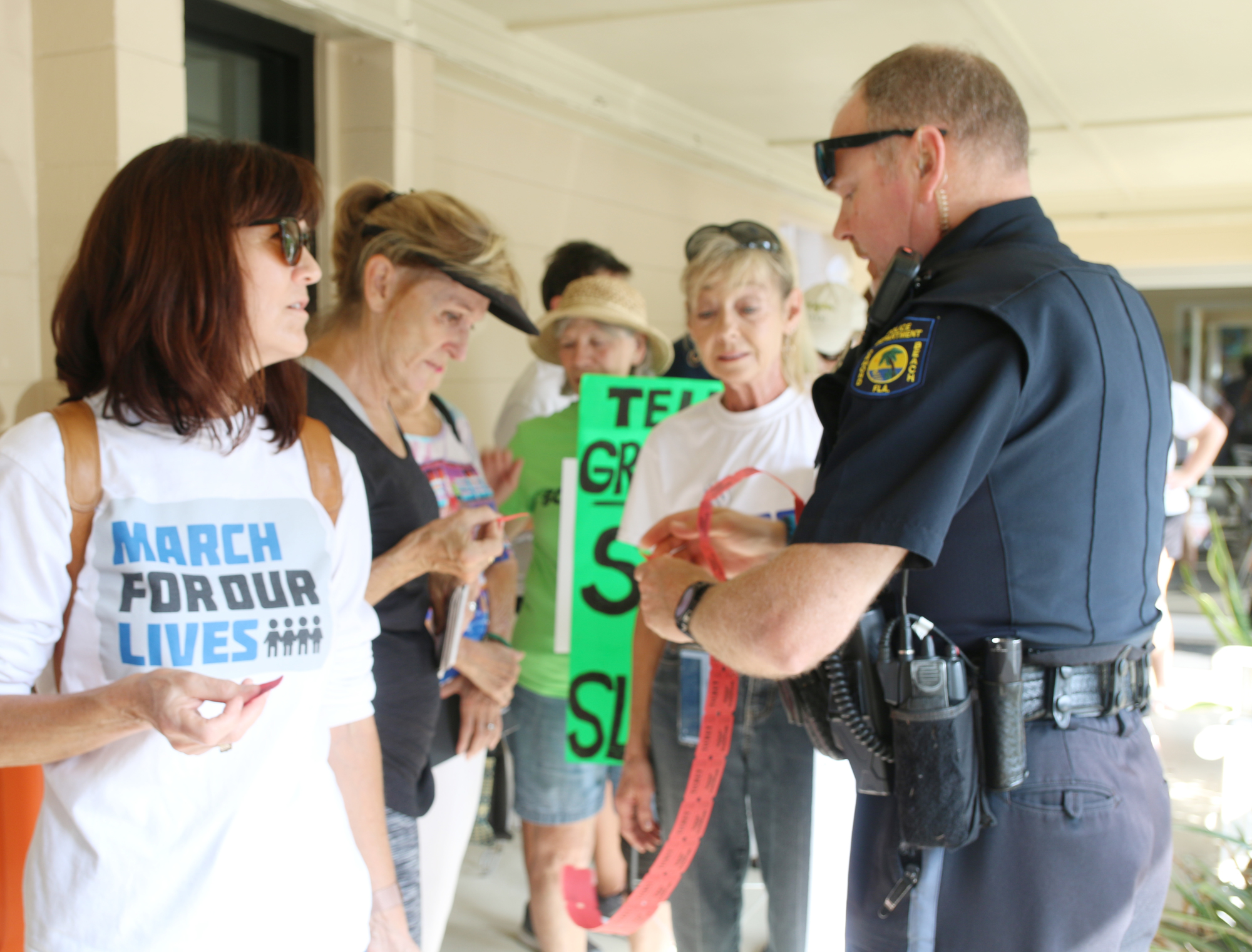 An Ormond Beach police officer hands out tickets for residents during Sen. Marco Rubio's mobile office hours on Thursday, Aug. 8. Photo by Jarleene Almenas