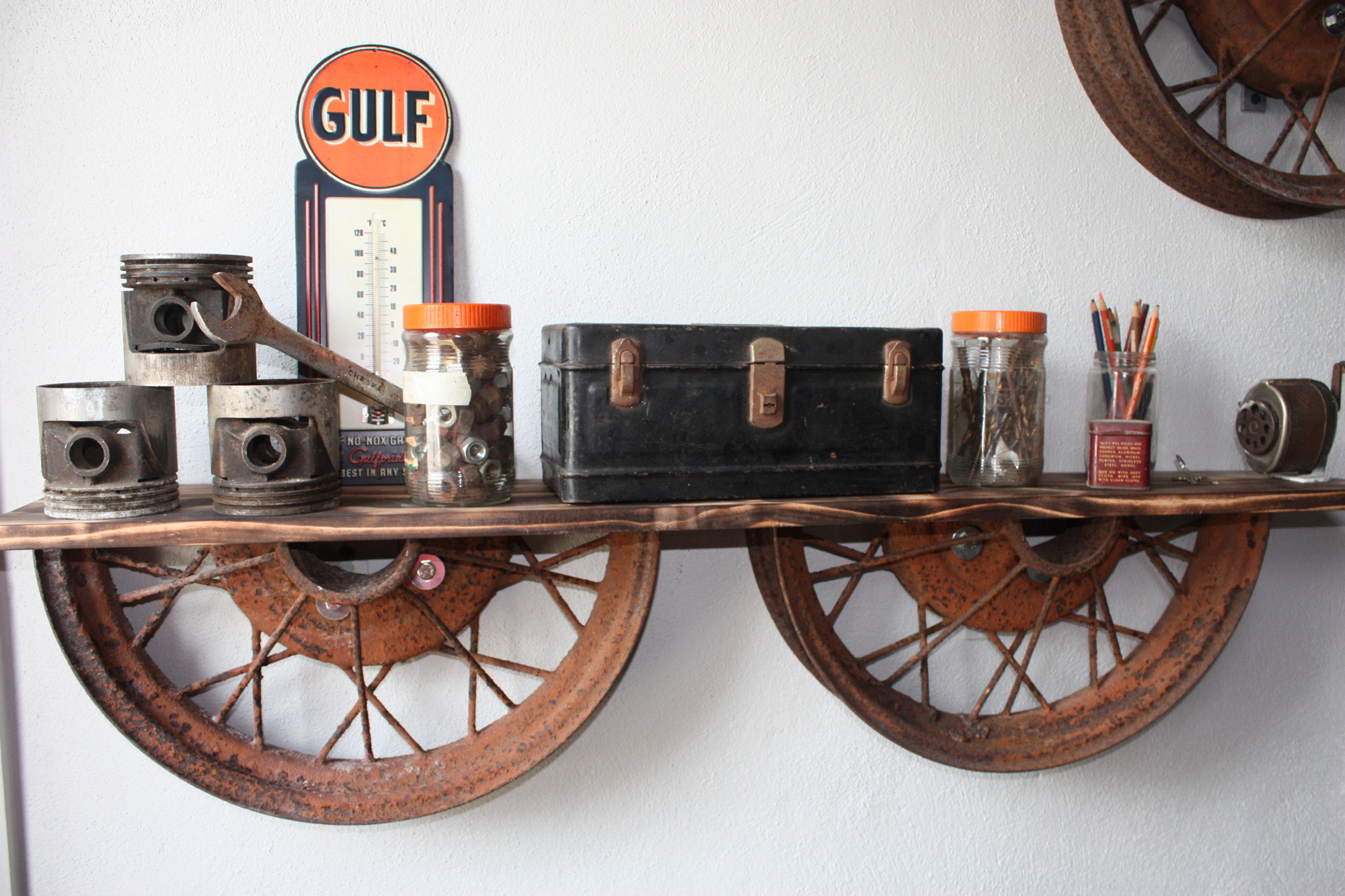 Items from Bud Pike’s workshop are displayed on a shelf made from antique wheels. Photo by Wayne Grant