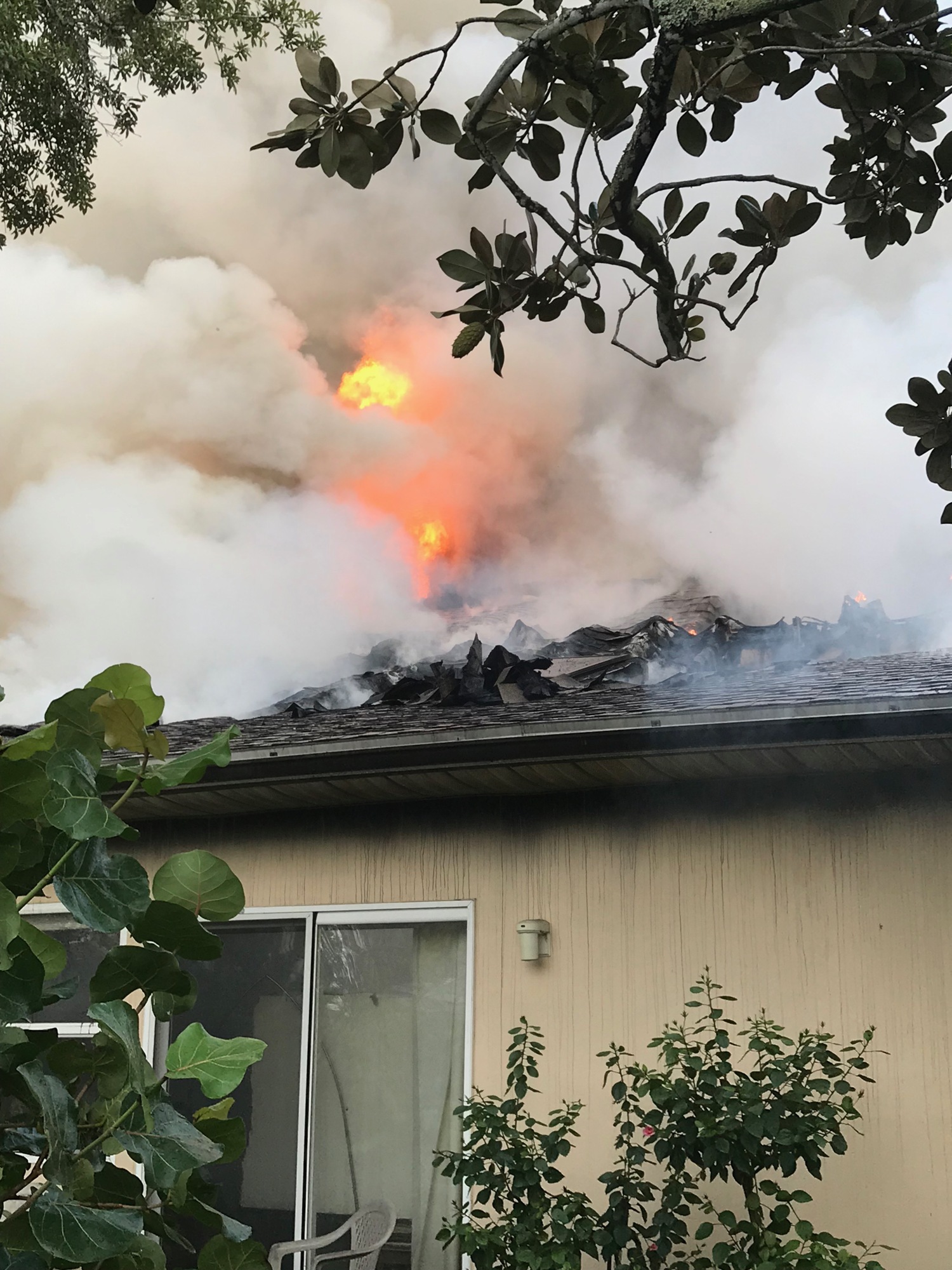 Flames are visible on the roof of a two-story house on Crystal Circle after it caught fire Friday afternoon. Courtesy photo