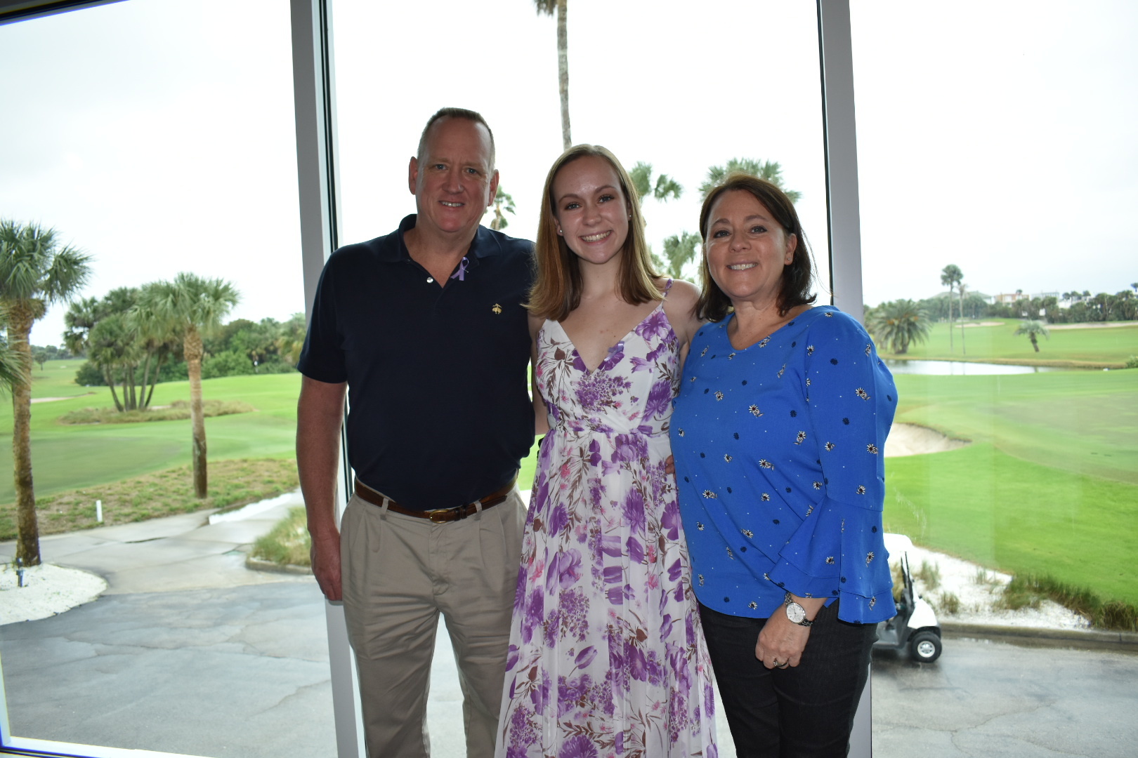 Taylor Olsen with her parents John and Carol at the Dressember Tea on Jan. 4. Courtesy photo