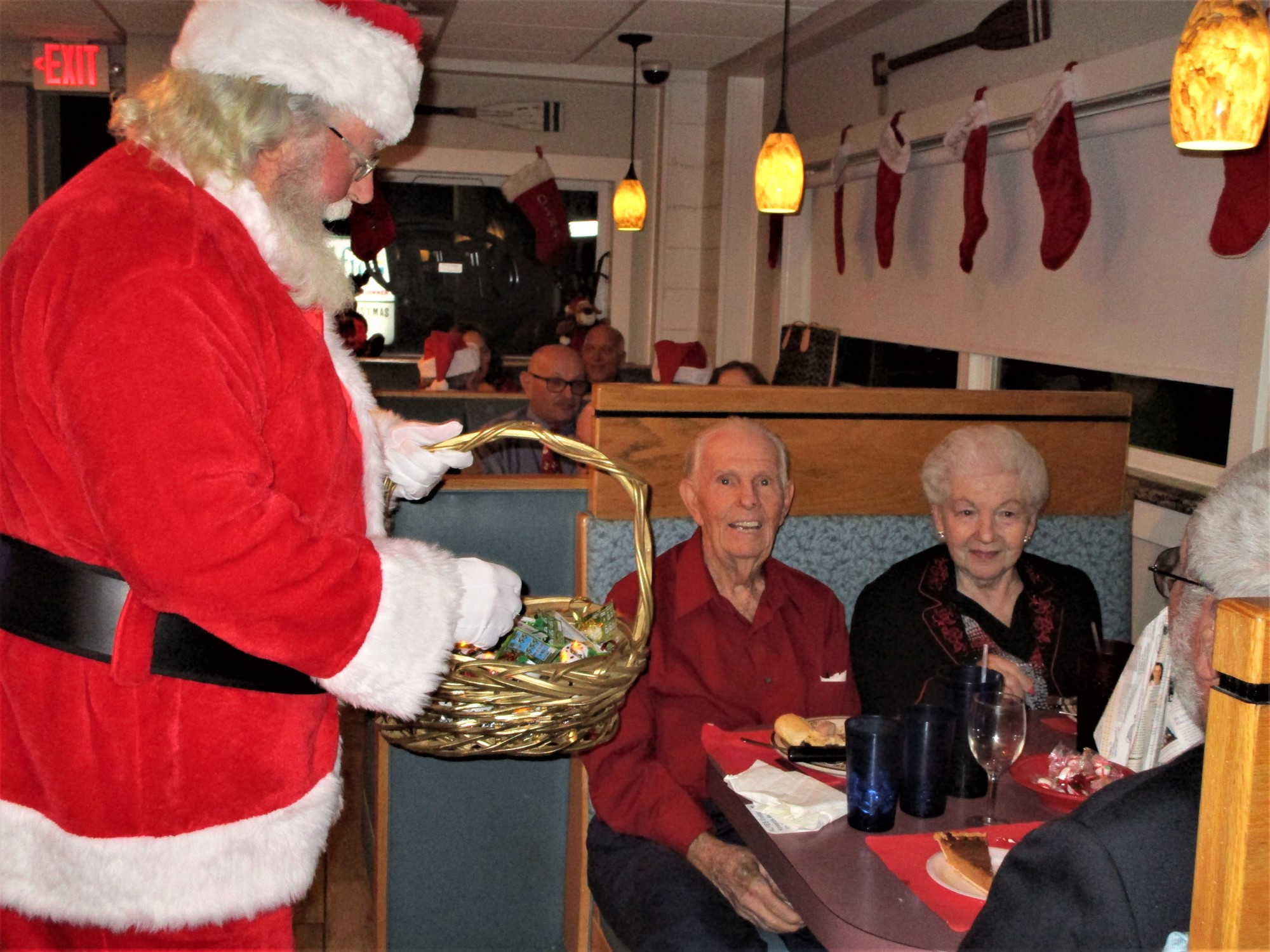 Santa hands out ornaments to Lions Harry and Gwen Dean. Courtesy photo