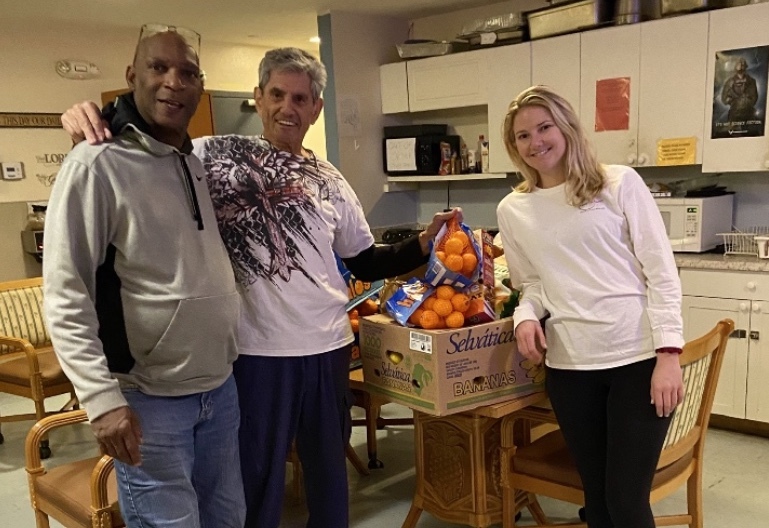 Bernard Sipps at Barracks of Hope, a Veterans Shelter receives food support from Marvin and Sarah Miller of The Jewish Federation.  Courtesy photo