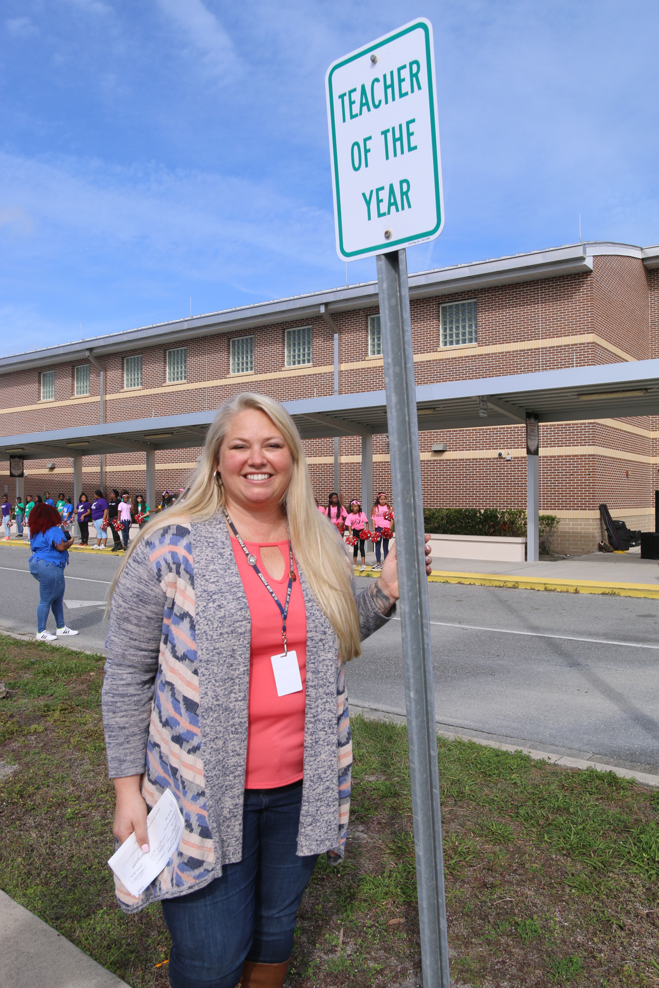 Holly Hill School fifth grade teacher Josie Stumpf stands beside the sign designating her new parking spot. Photo by Jarleene Almenas