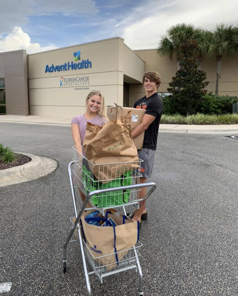 Sarah Heaster and fellow volunteer Trent Provenzano deliver food for a local patient battling cancer. Both attend Spruce Creek High School. Courtesy photo