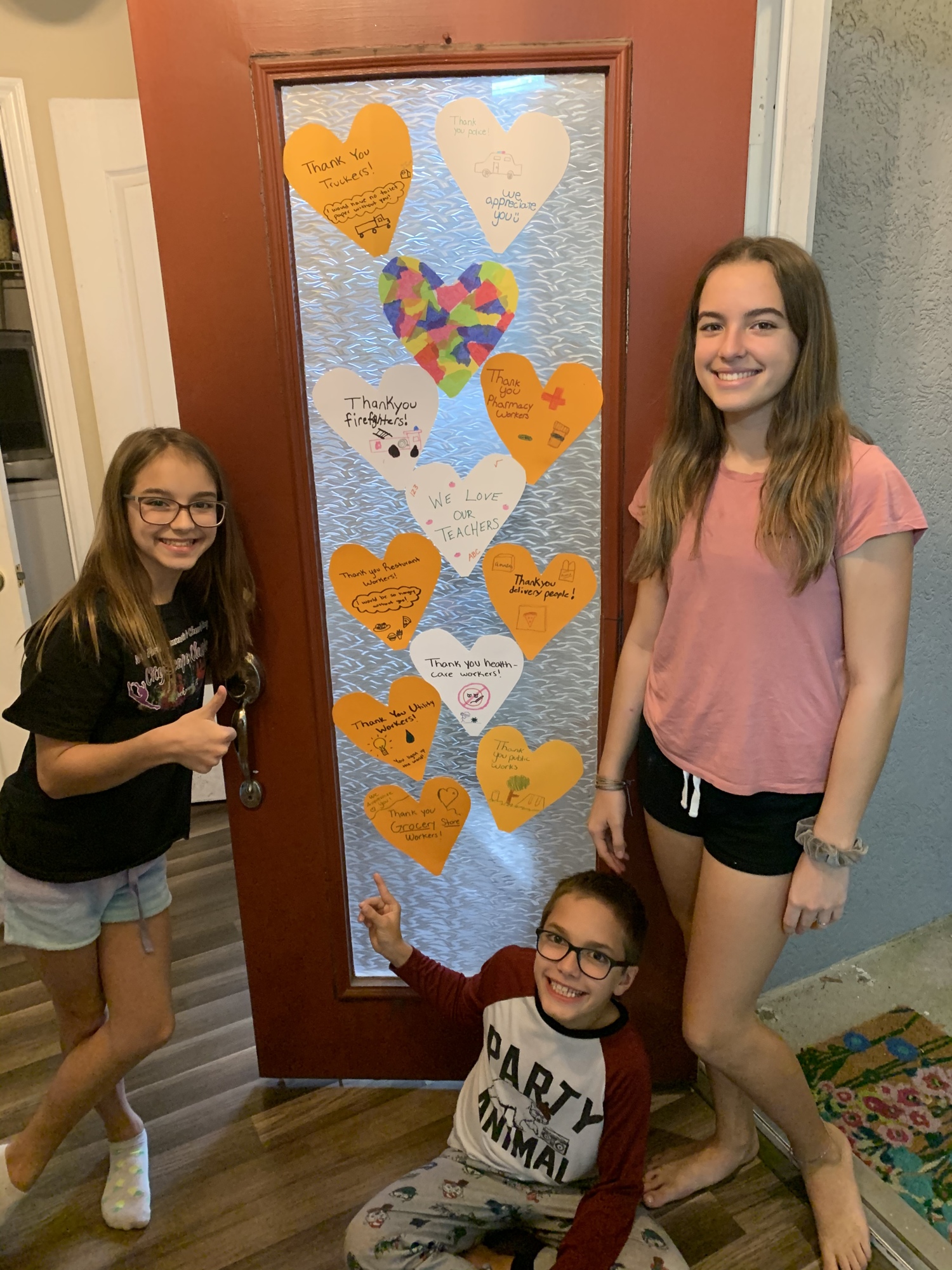 Taylor, Owen and Brooke Elston show off their decorated front door. Courtesy photo