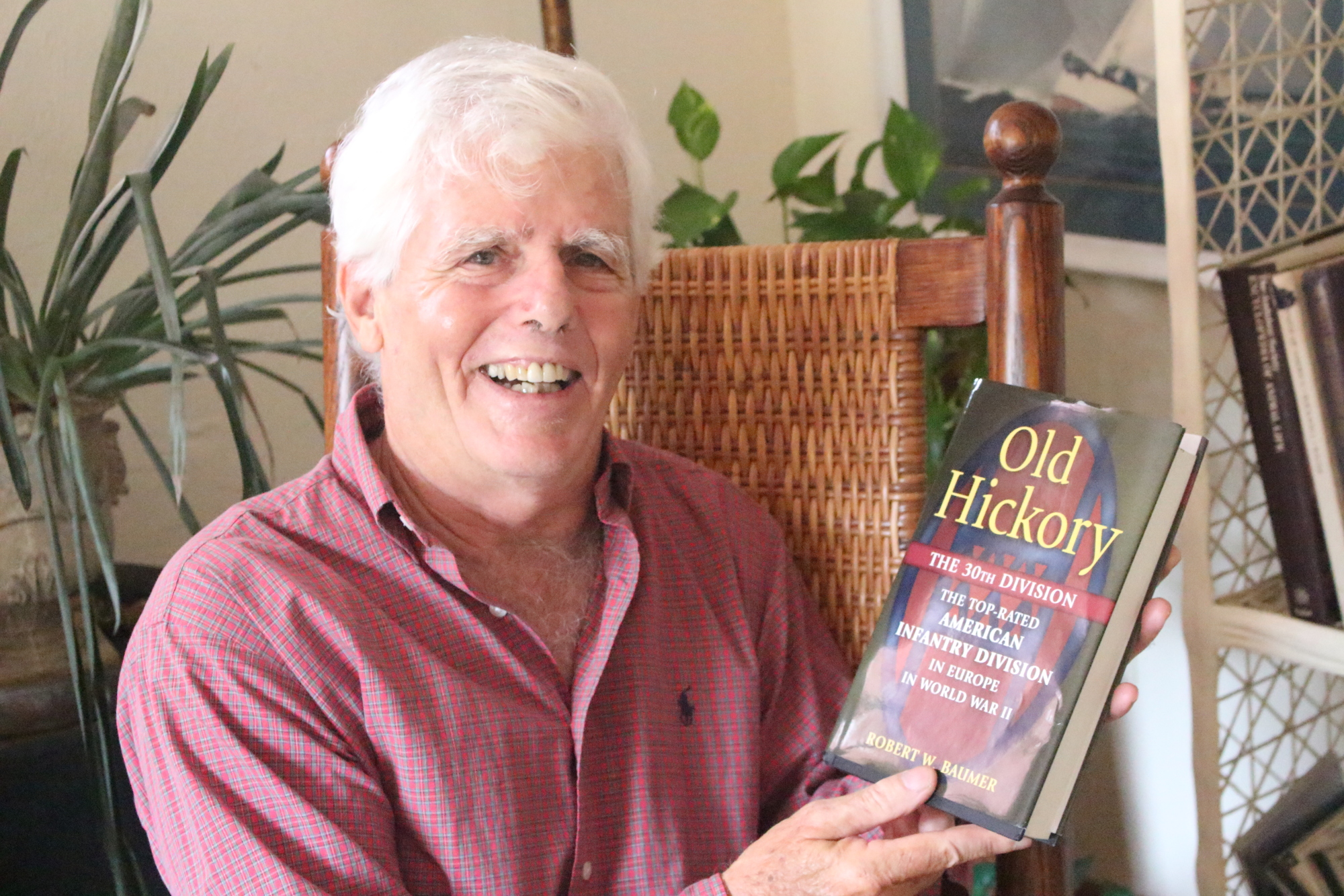 Ormond Beach resident Robert Baumer with his book about the 30th Infantry Division in 2017. File photo