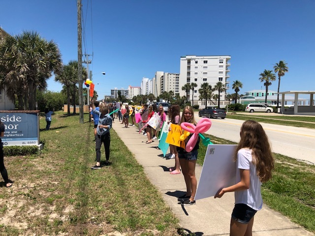 St. Brendan Catholic School students hold signs outside Seaside Manor. Courtesy photo