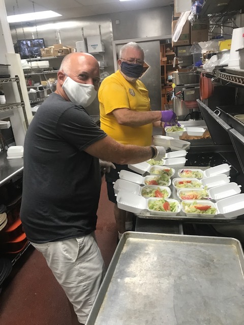 Lions Jeff Graham and Les Walter make salads for local businesses, offices, stores and shops in the Ormond-by-the-Sea community. Courtesy photo