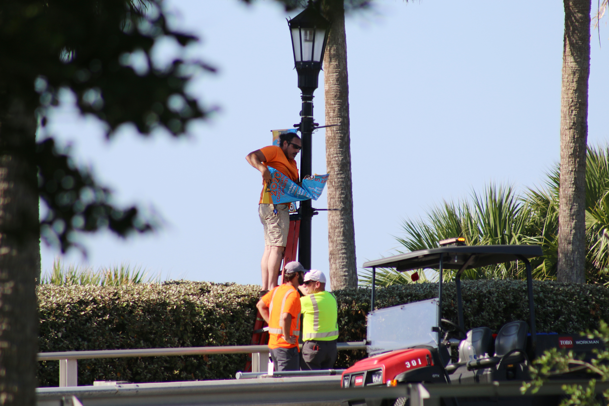 Ormond Beach Public Works employees put up the banners on Friday, May 22. Photo by Jarleene Almenas