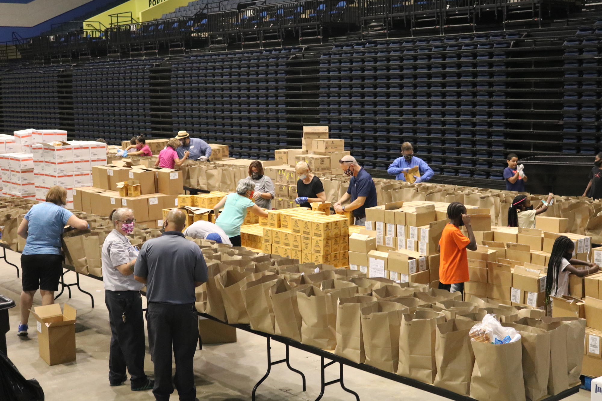 Volunteers help pack groceries for HUM's food distributions. Courtesy photo