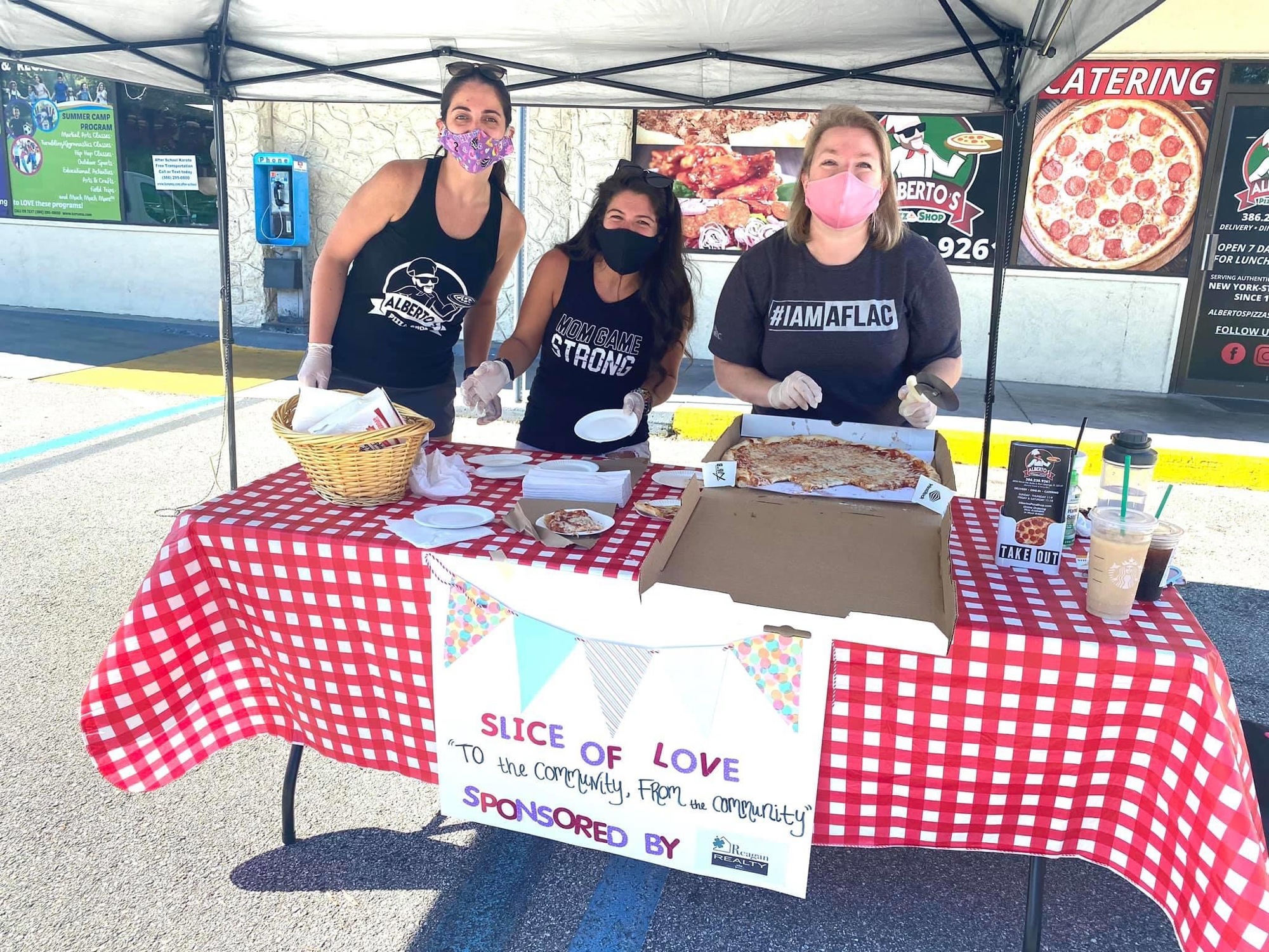 Rosa Ruby, Nicole Chapman, Tammi Williams man the pizza table at the giveaway on Saturday, Aug. 8. Courtesy photo