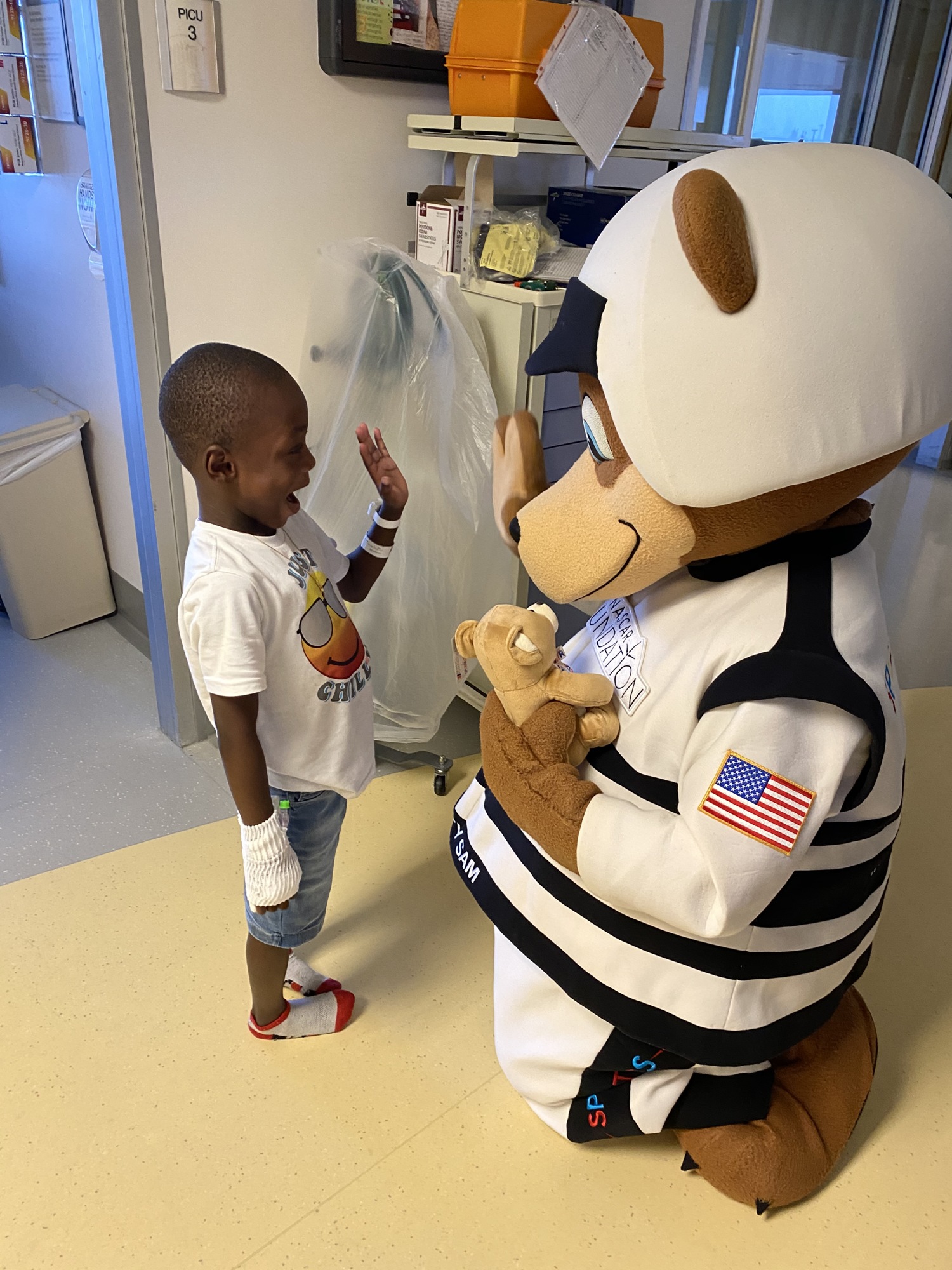 Safety Sam high-fives a pediatric patient at Halifax Health. Courtesy photo