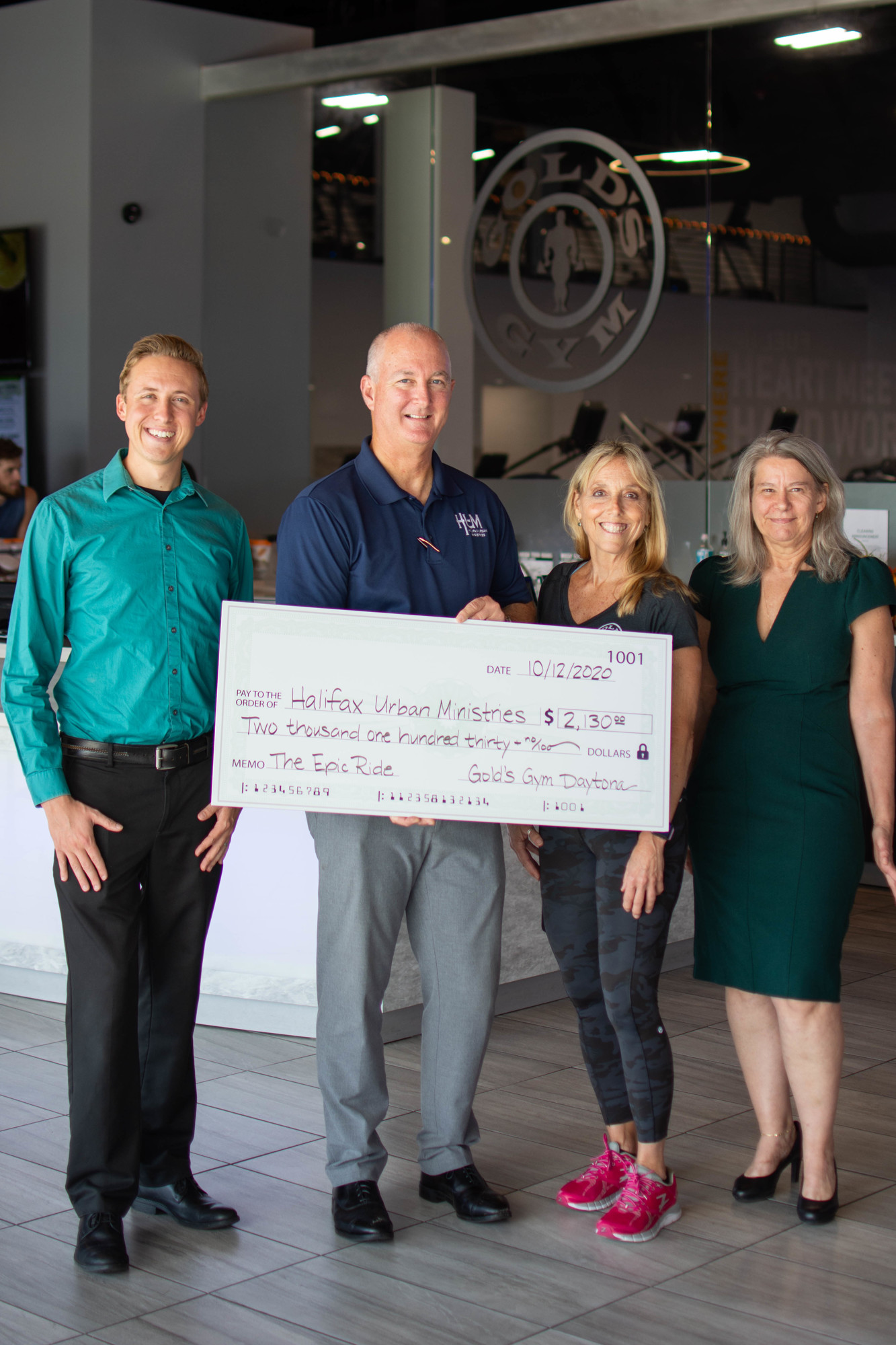 Gold's Gym presents Buck James , Executive Director of HUM, with a check for $2100 dollars. Courtesy photo