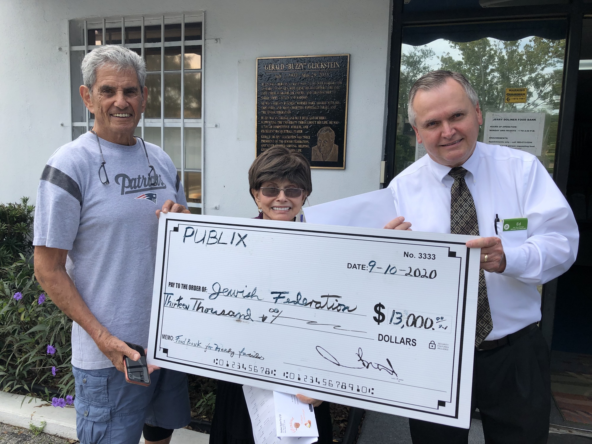 Publix Ormond Towne Square Assistant Store Manager Ed Barthpresents a check to Jewish Federation President Marvin Miller and Executive Director Gloria Max. Courtesy photo