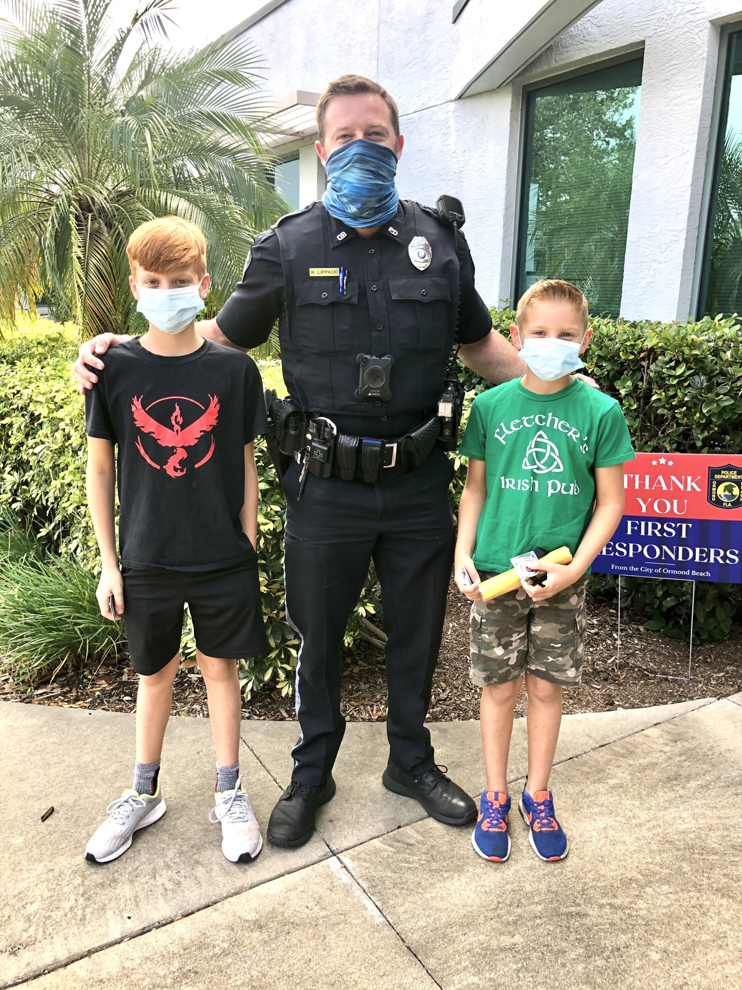 Billy and Connor Fletcher with Officer Karl Lippack. Courtesy photo