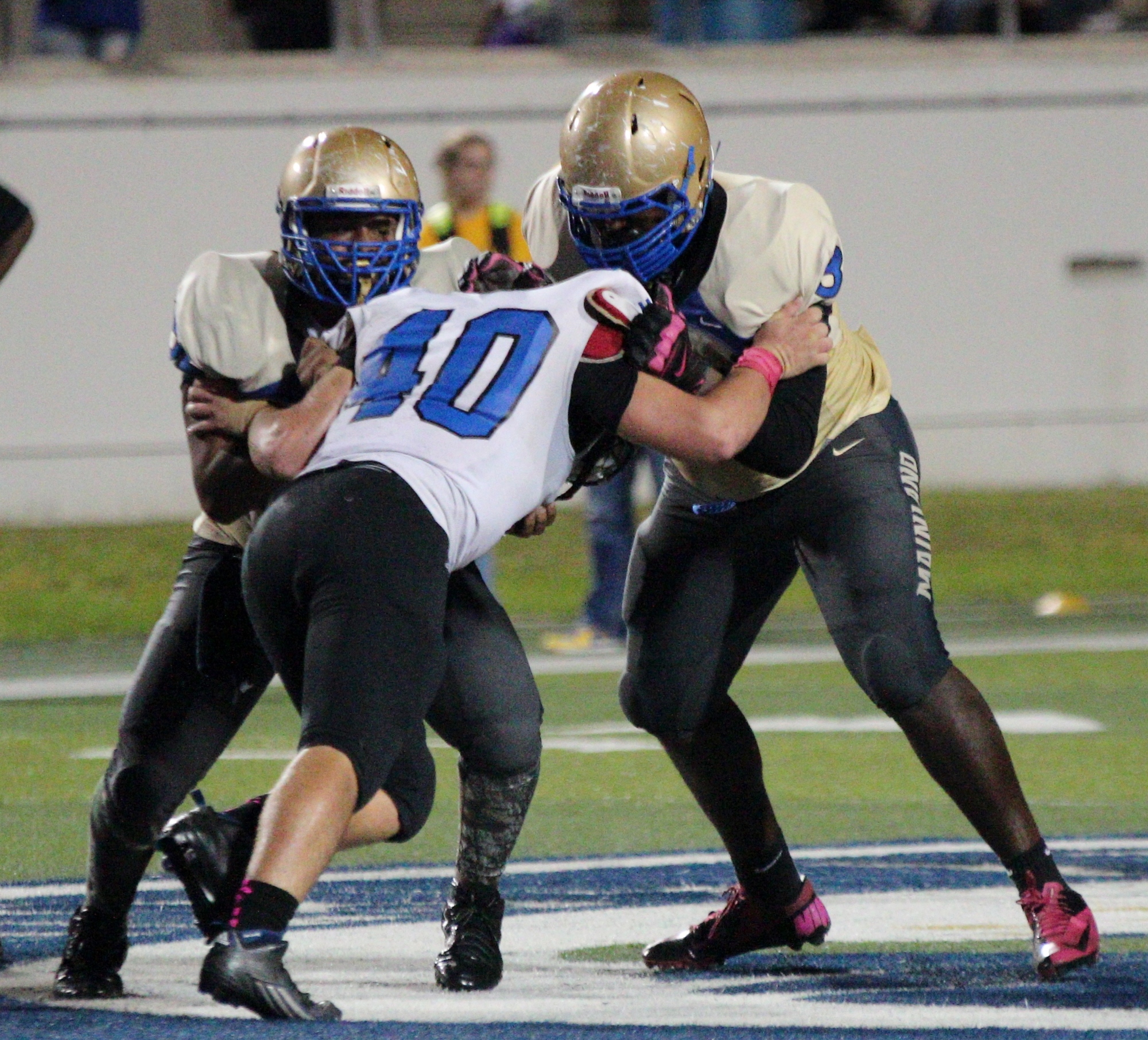 George Pardiny takes on two Mainland linemen who both are taller and bigger than he is.