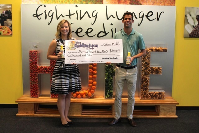 Chris Marlow presents Maureen Mike of Second Harvest Food Bank with a check for $1,000.