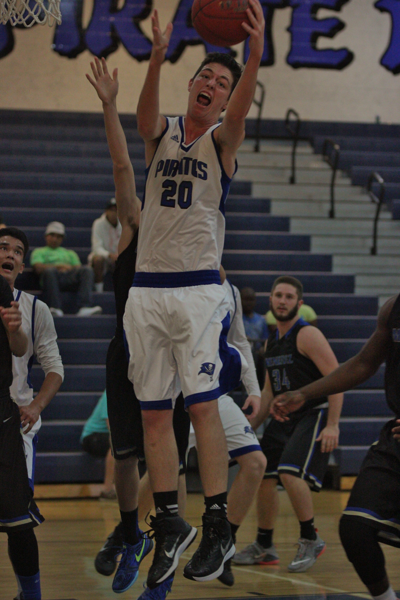 Cam Rees grabs a defensive rebound against Menendez. Photos by Jeff Dawsey