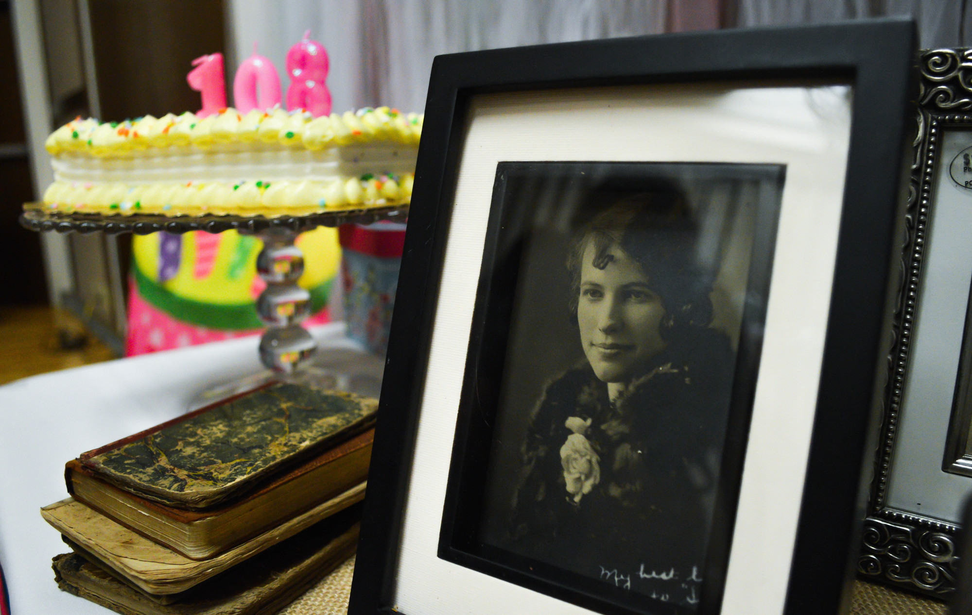 Photos of Buffles from throughout her long life are displayed next to her birthday cake at the surprise party on May 18. Photo by Paige Wilson