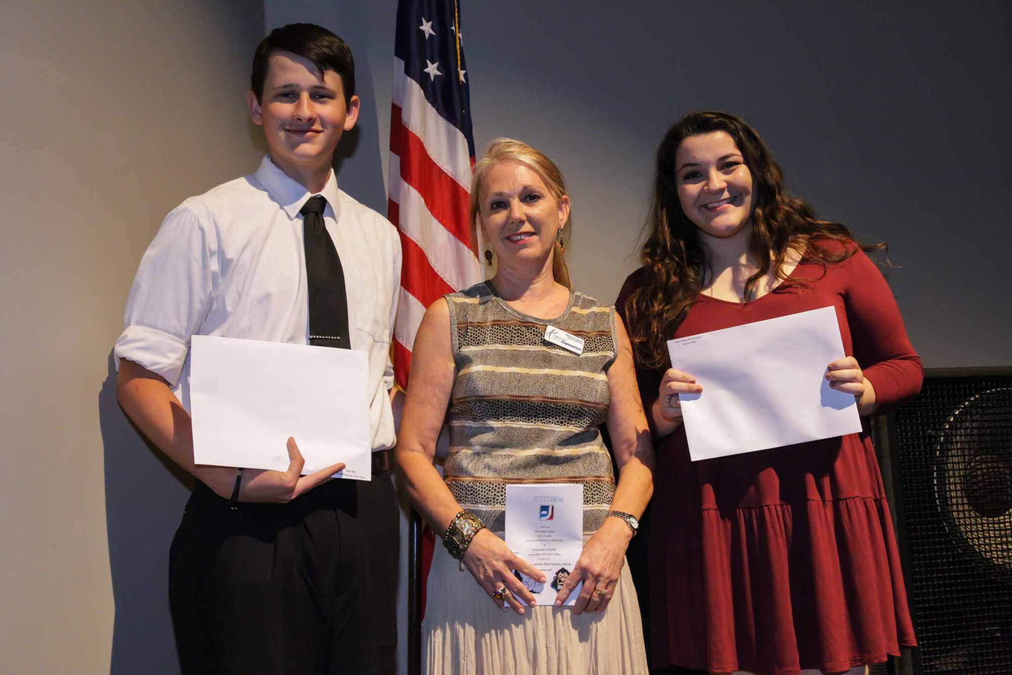 Scholarship winners Tyler Wise and Kathleen Wells with PCAF Executive Director Nancy Crouch in center. Photo courtesy of Palm Coast Arts Foundation