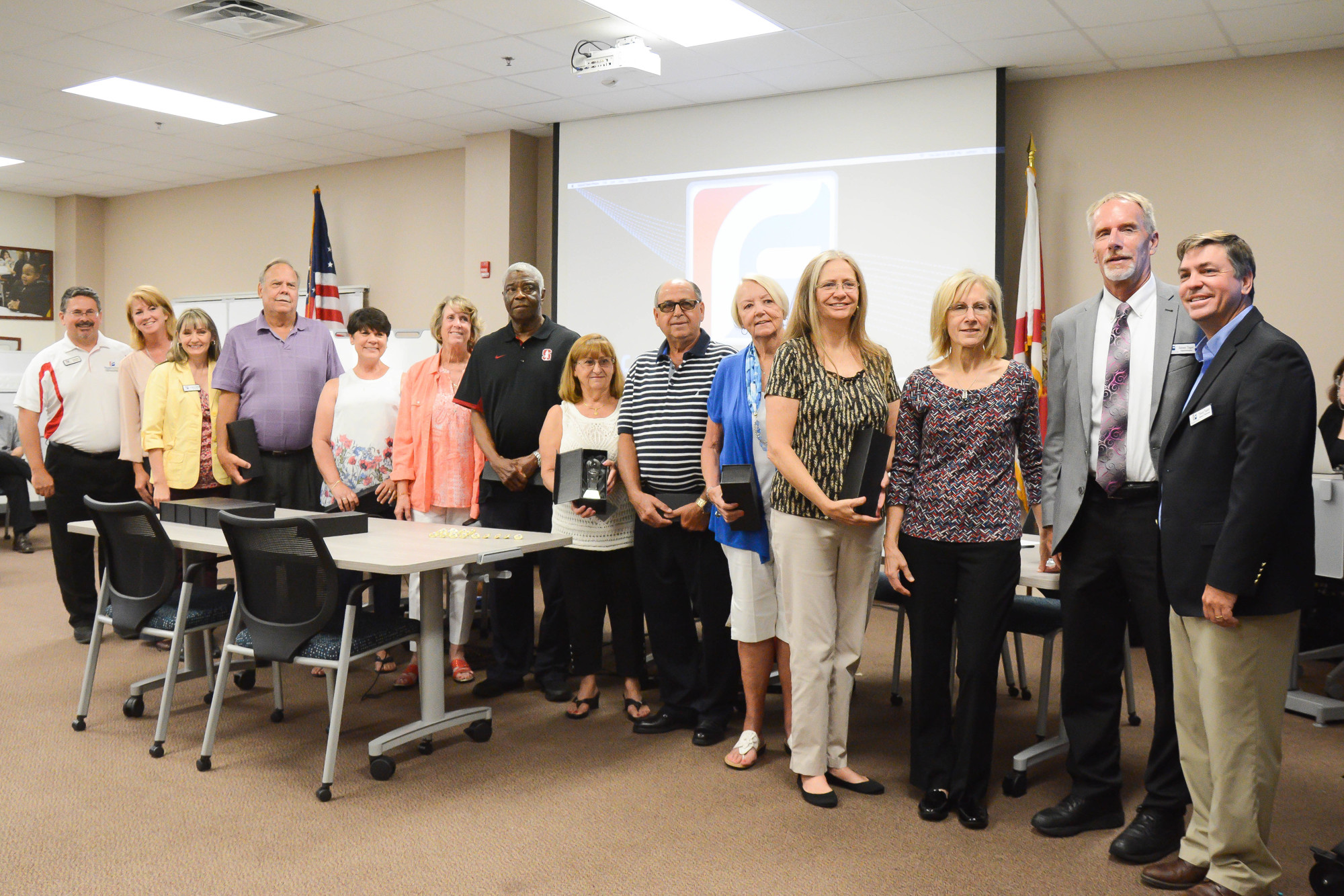 Flagler School Board members stand with a group of county retirees. Photo by Paige Wilson