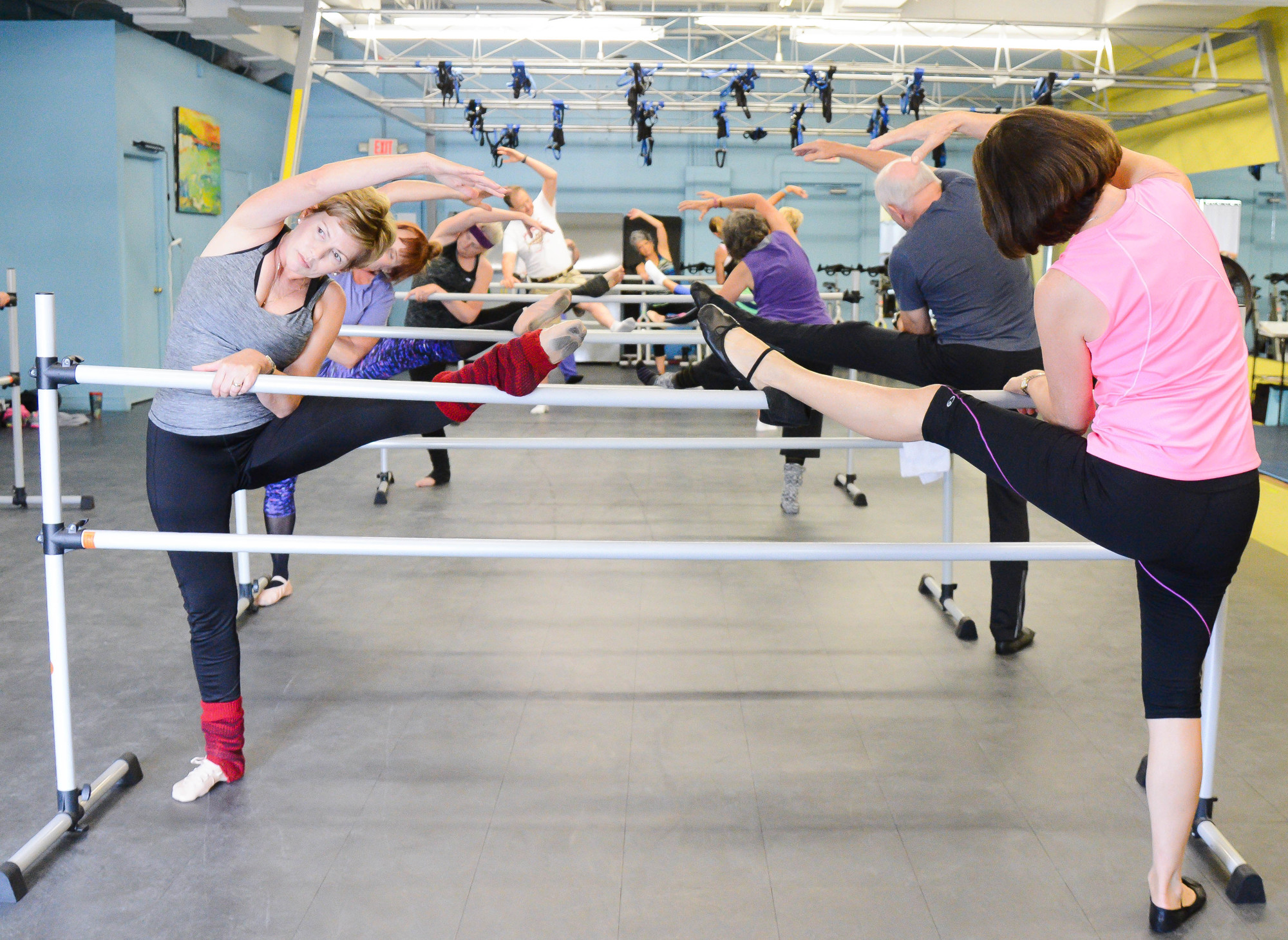 Angela Camit, 59, (left) and Ursula Pfeil, 74, (right) take part in the Pilates barre class. Photo by Paige Wilson