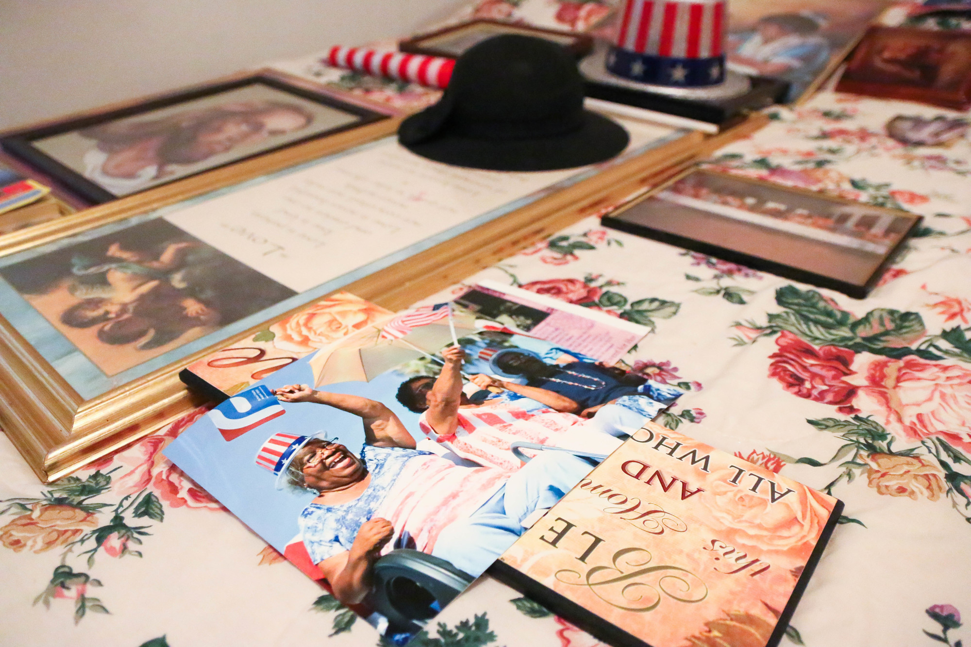 Photos and mementos rest on a guest bed in Luella Johnson's Palm Coast home. Photo by Paige Wilson