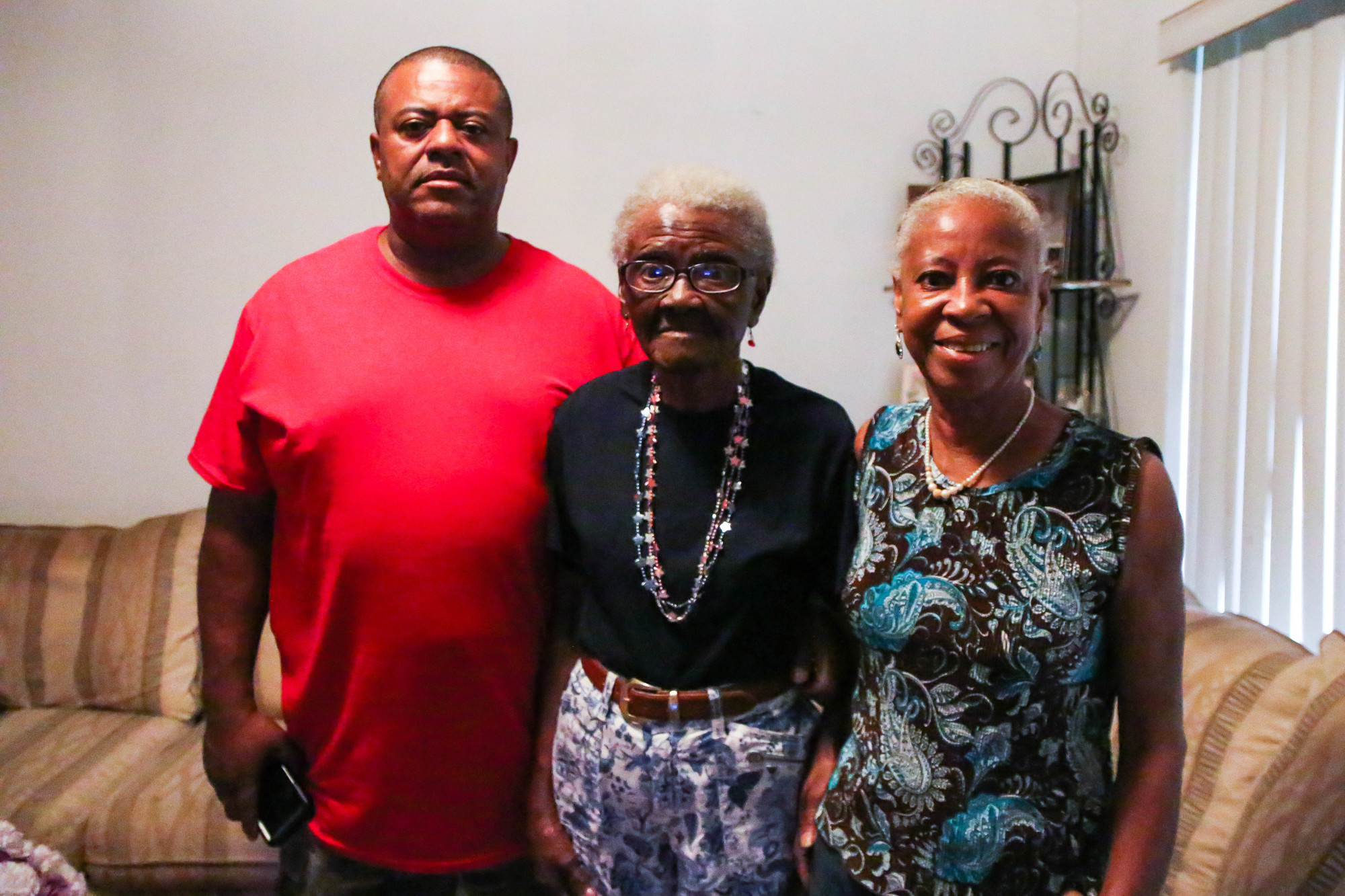 Freddie Johnson, left, and Gloria Shavers, right, stand with their mother Luella Johnson. Photo by Paige Wilson