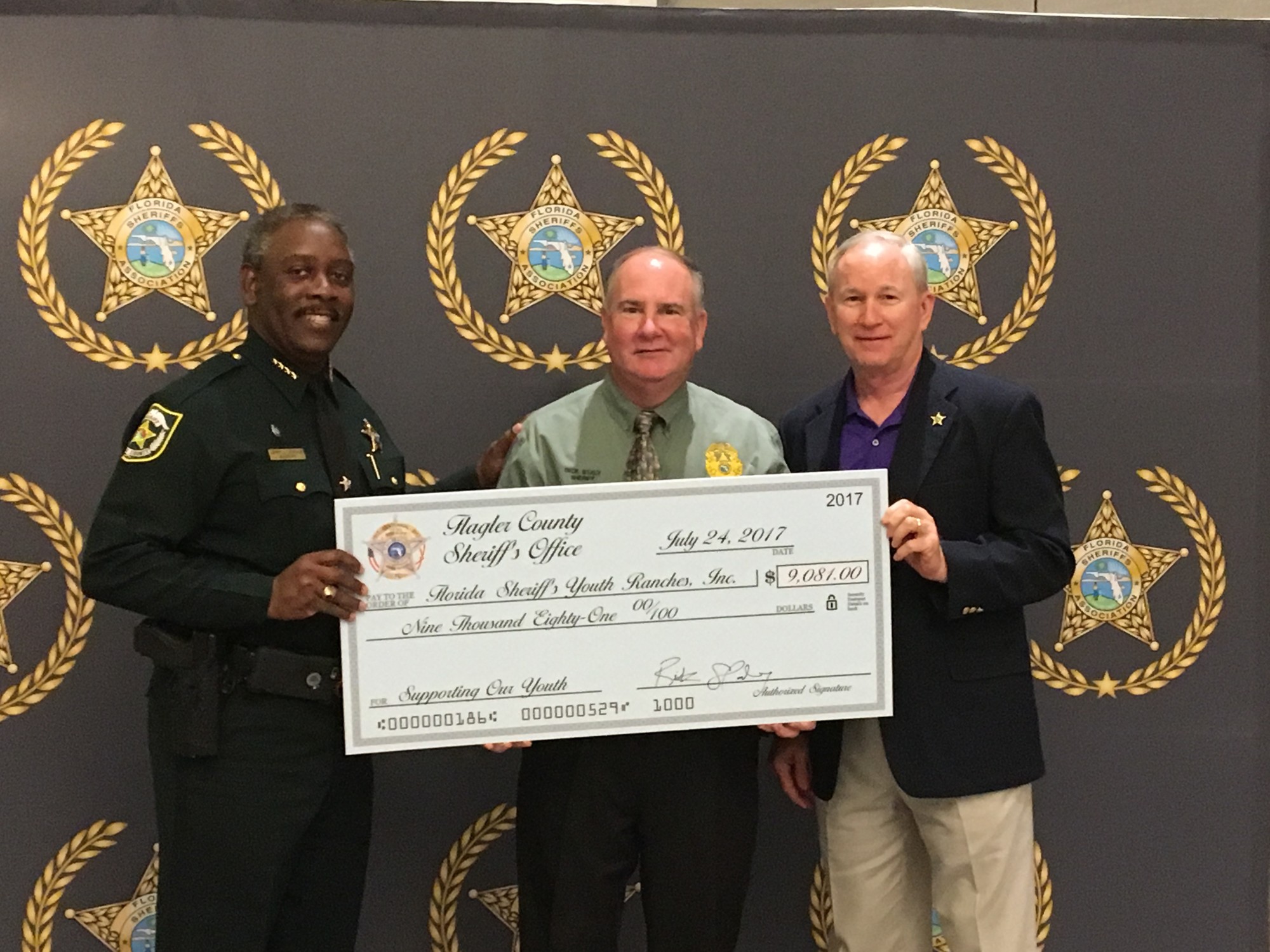 Orange County Sheriff Jerry Demings, Flagler County Sheriff Staly and Nassau County Sheriff Bill Leeper present a check to benefit Florida Sheriff's Youth Ranches Board of Directors. Photo courtesy of Palm Coast