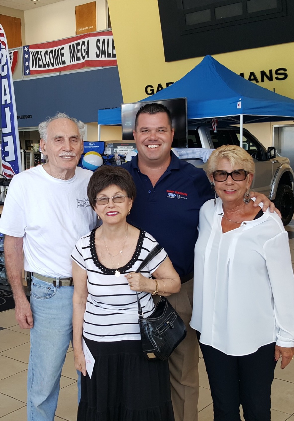 Angelete Birmingham (front right) and Jeromie Alan (back right) presented the check to Gloria Max, executive director of the Jewish Federation of Volusia & Flagler Counties (front left) and her husband Ray (back left).