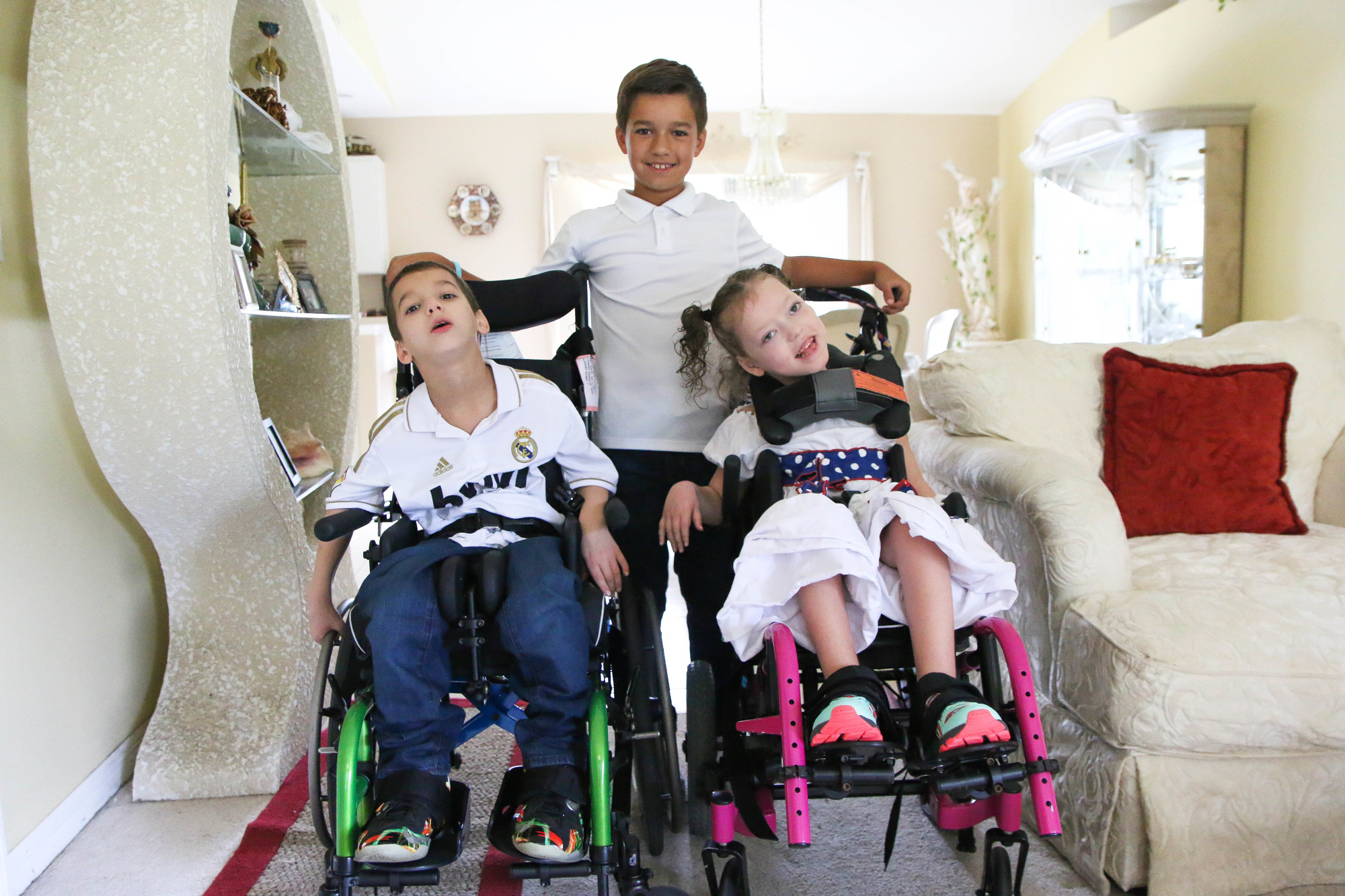 Landon Grover, 11, stands behind his brother Brayden, 10, and his sister Alaina, 7. Photo by Paige Wilson