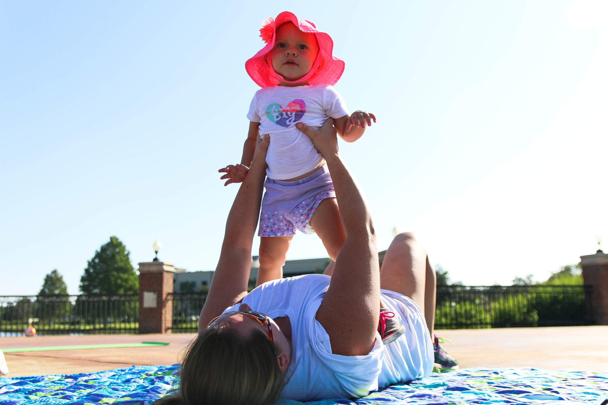 Jennifer Graves holds up her 1-year-old daughter Breelyn during the Mommy and Me Fit Camp. Photo by Paige Wilson