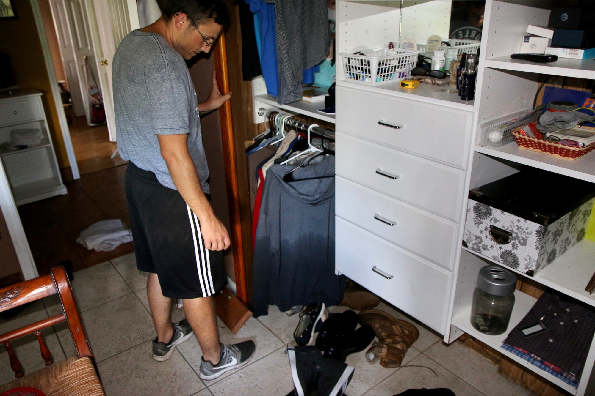 Sivan Shany points to the water mark left in his closet after the Oshris' home was flooded by Hurricane Irma. Photo by Ray Boone
